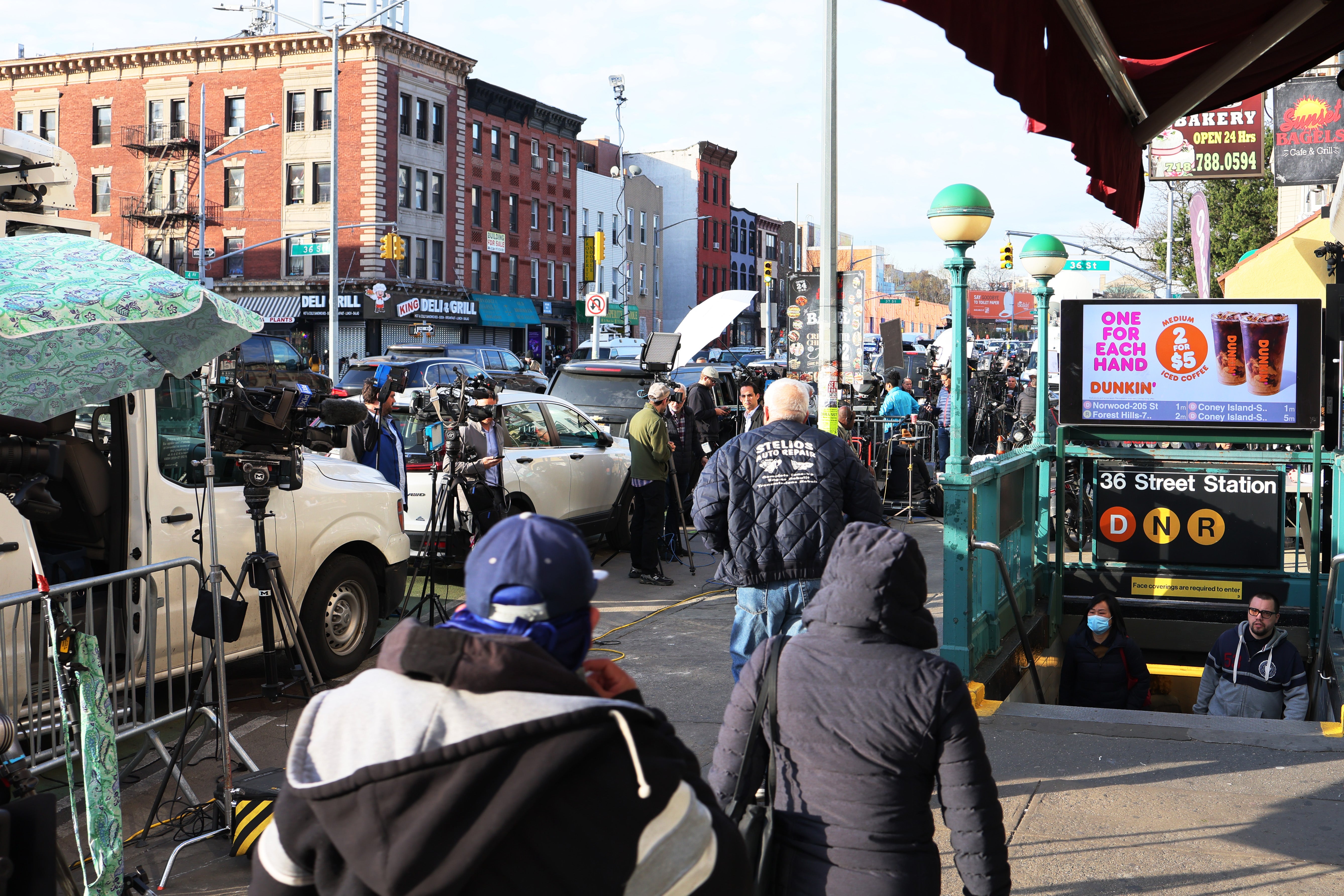 People head into the subway station in Sunset Park 24 hours after the attack