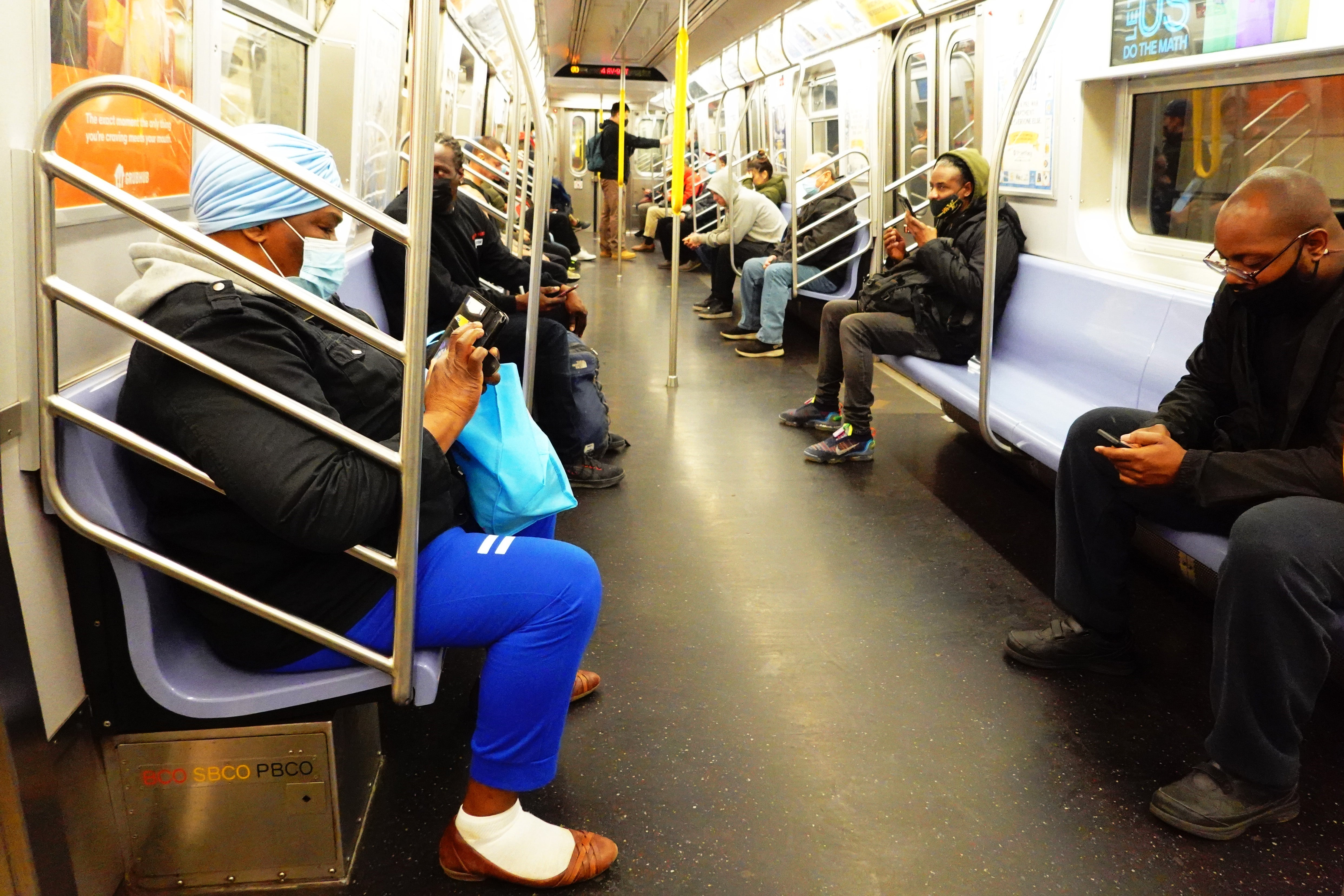 People ride the R train during the morning commute on Wednesday in the Sunset Park neighborhood of Brooklyn