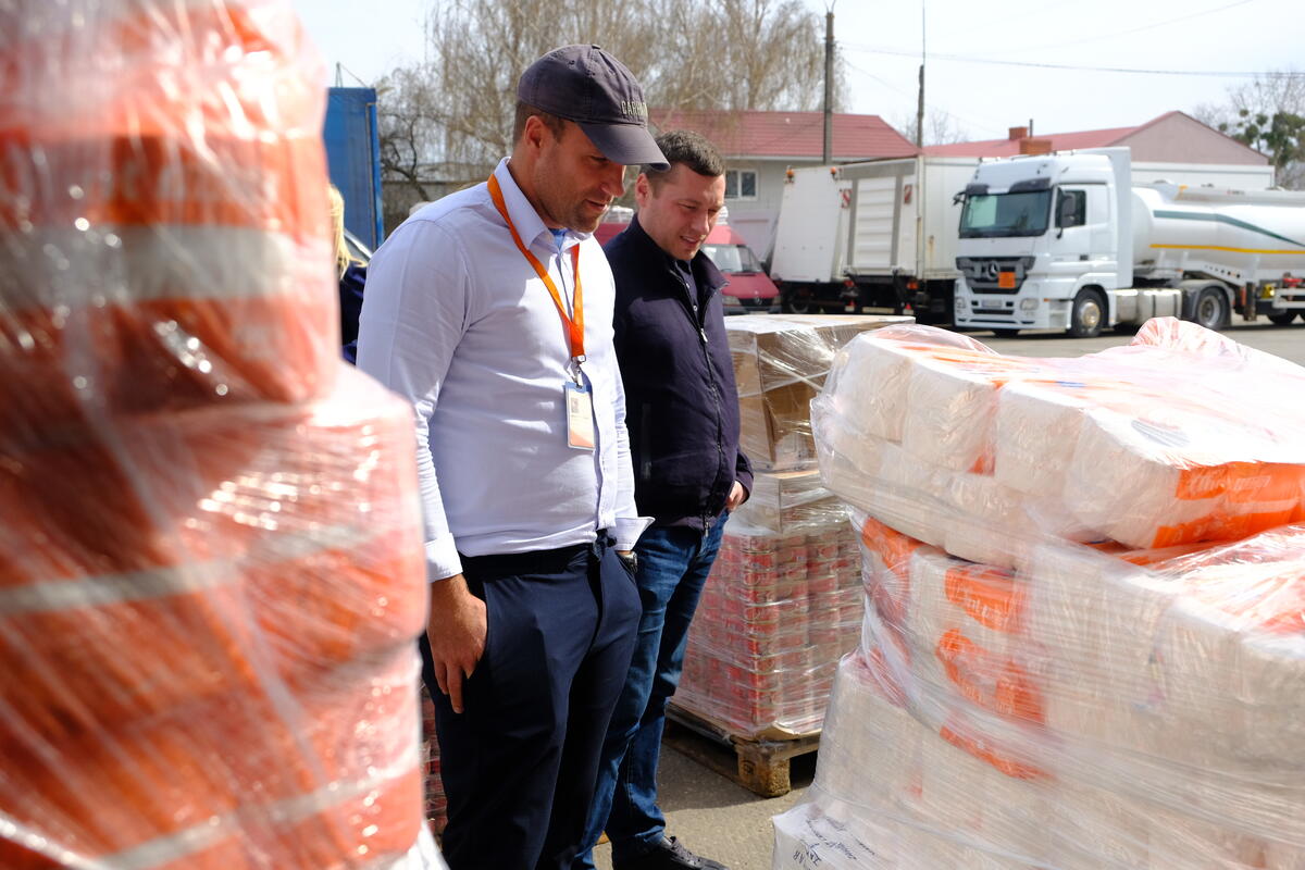 Locals in Chernivtsi load the donations into a van, helped by James Orlando (left). The items are bound for a school that is housing internally displaced people