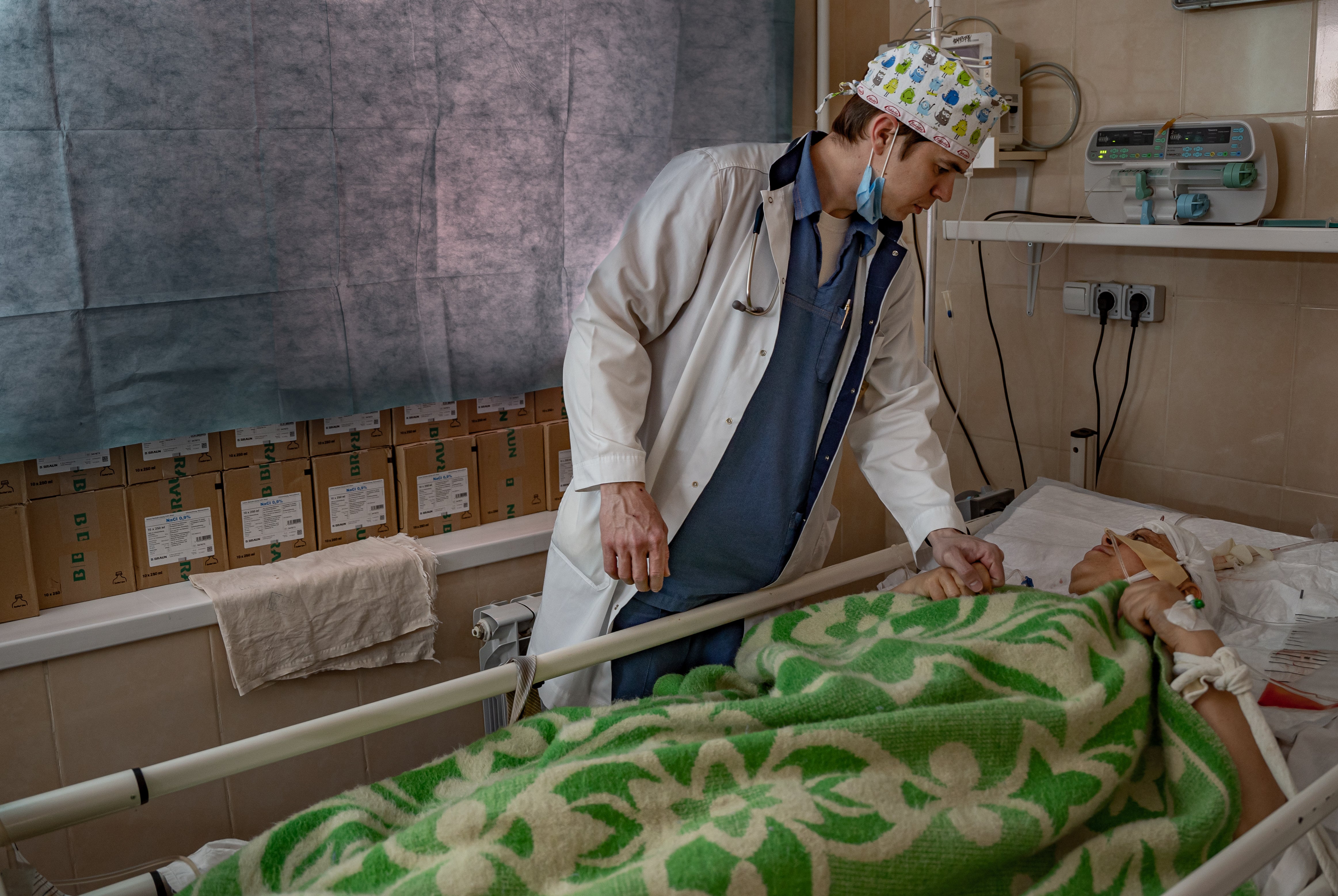 Dr Dymtro tends to a woman injured in a suspected cluster munition attack on the city centre