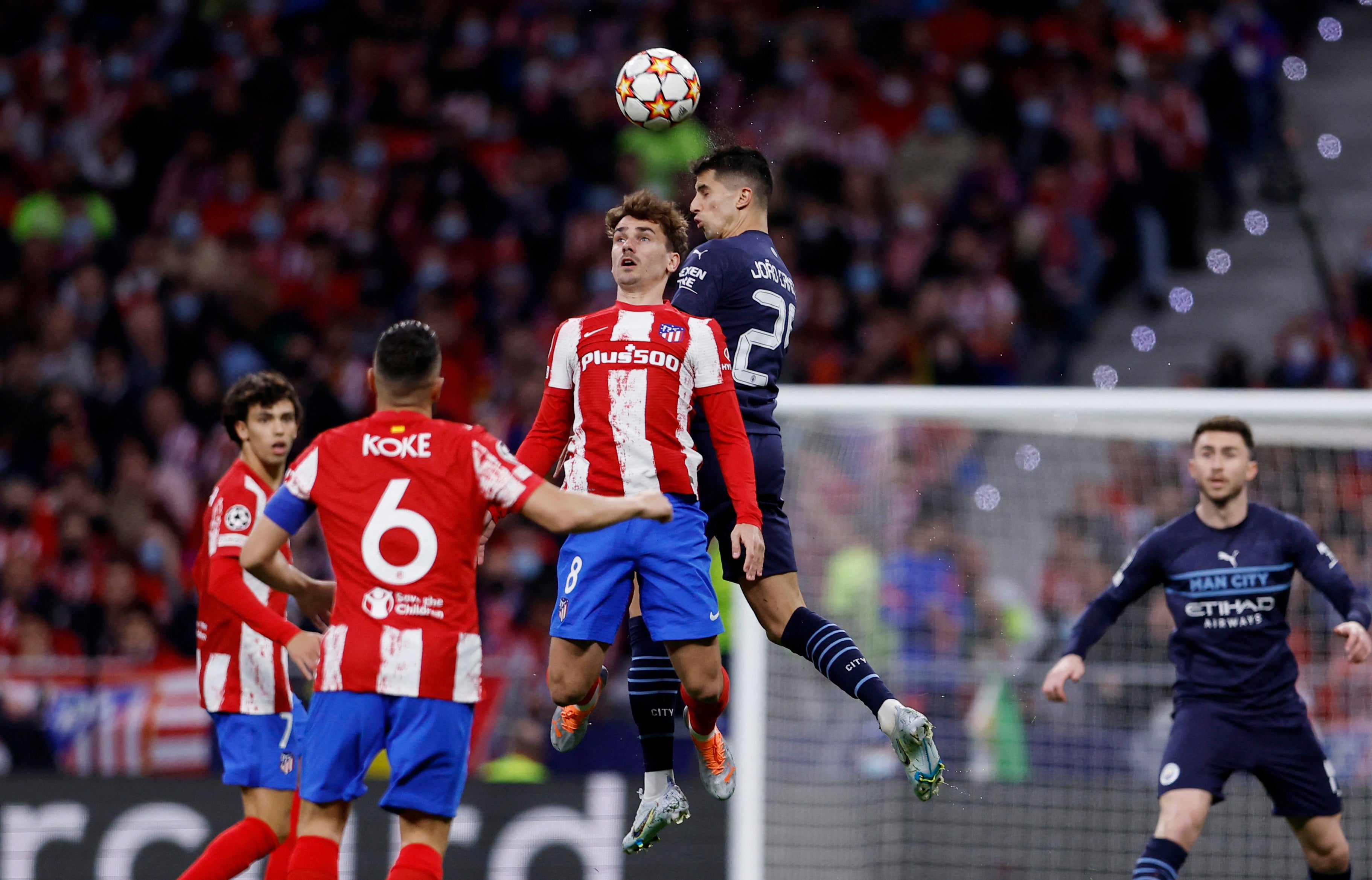 Antoine Griezmann leaps with Manchester City’s Joao Cancelo