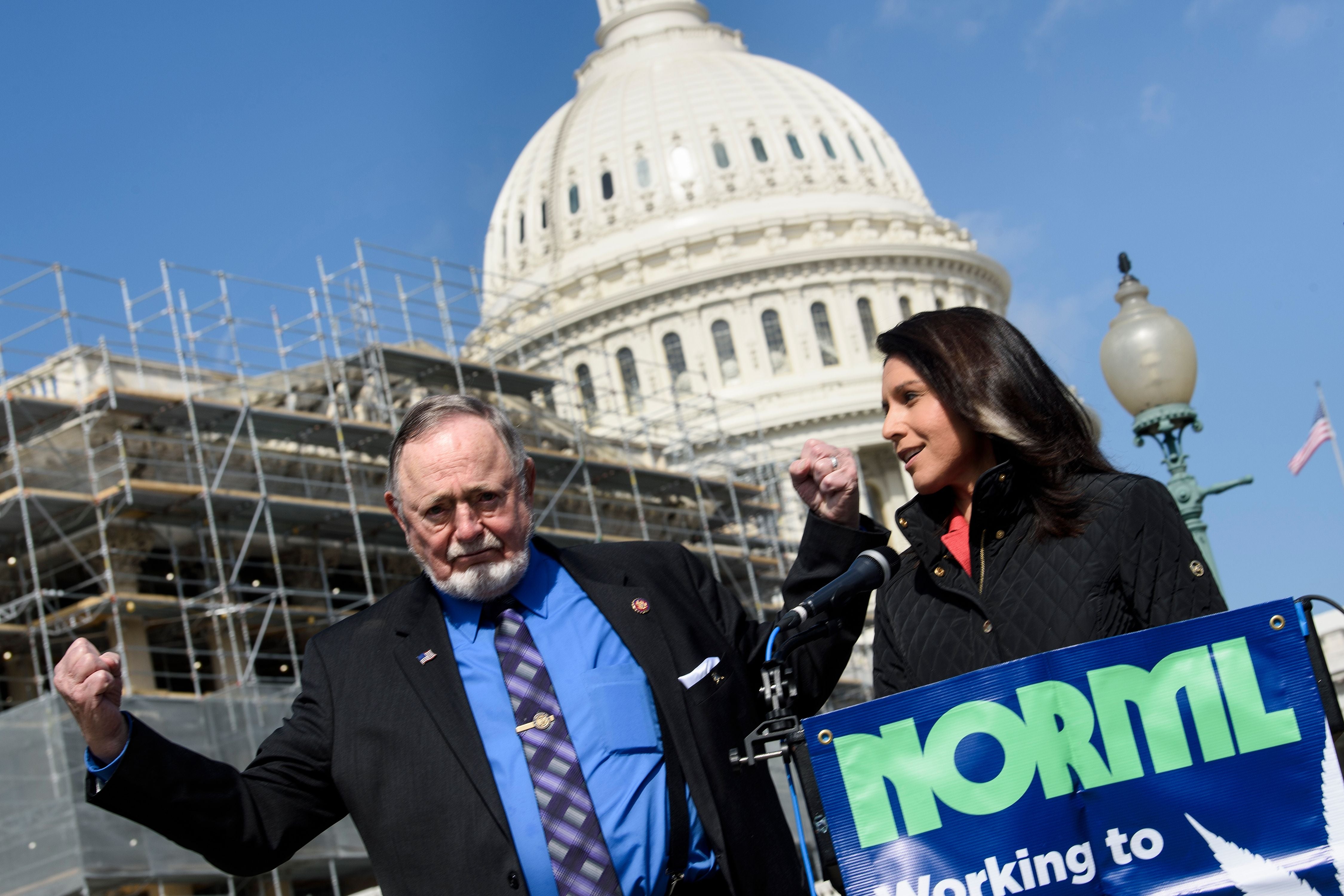 Don Young, (L) pictured in 2019 with Democrat Tulsi Gabbard represented Alaska for 49 years