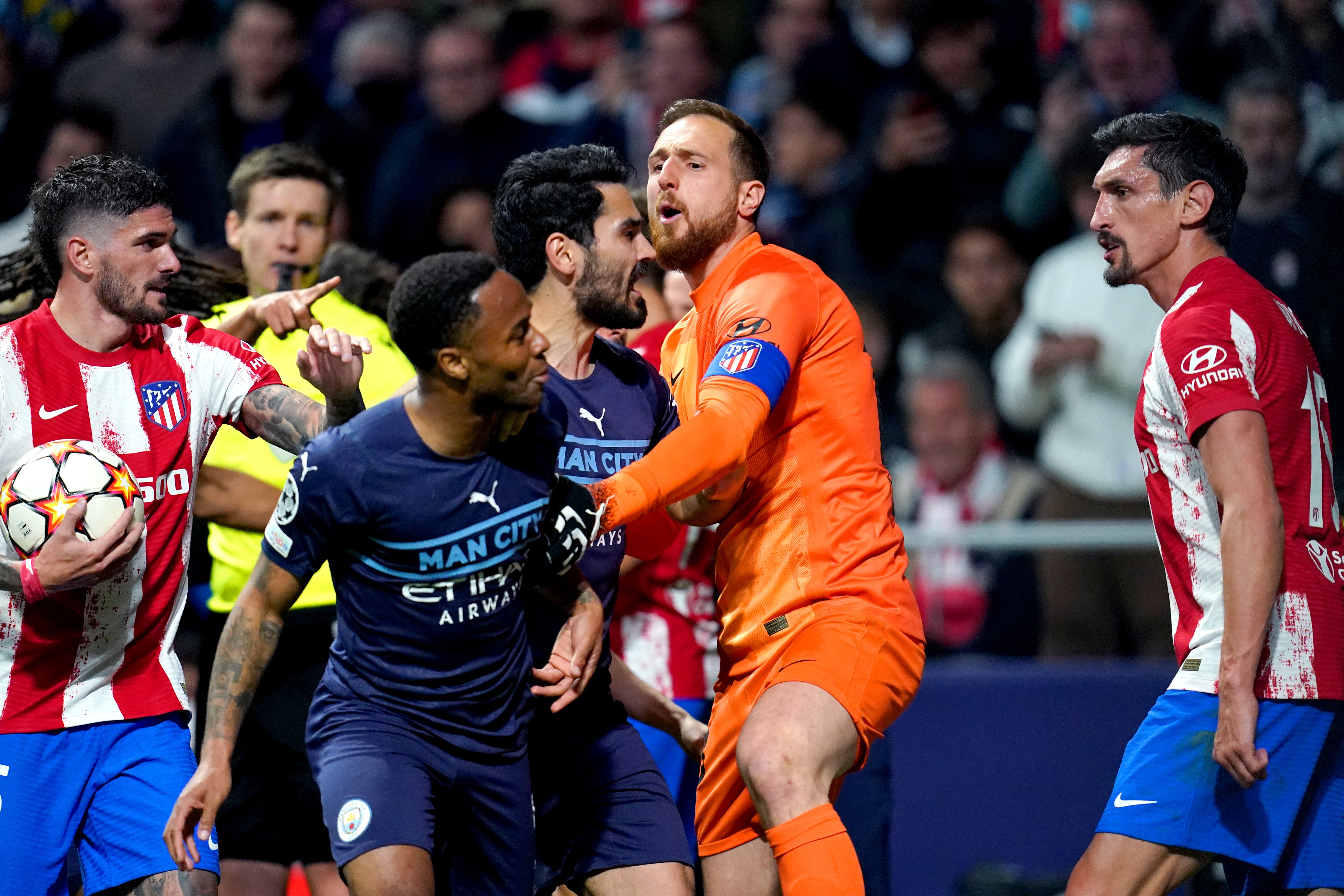 Jan Oblak holds back Raheem Sterling (Nick Potts/PA)