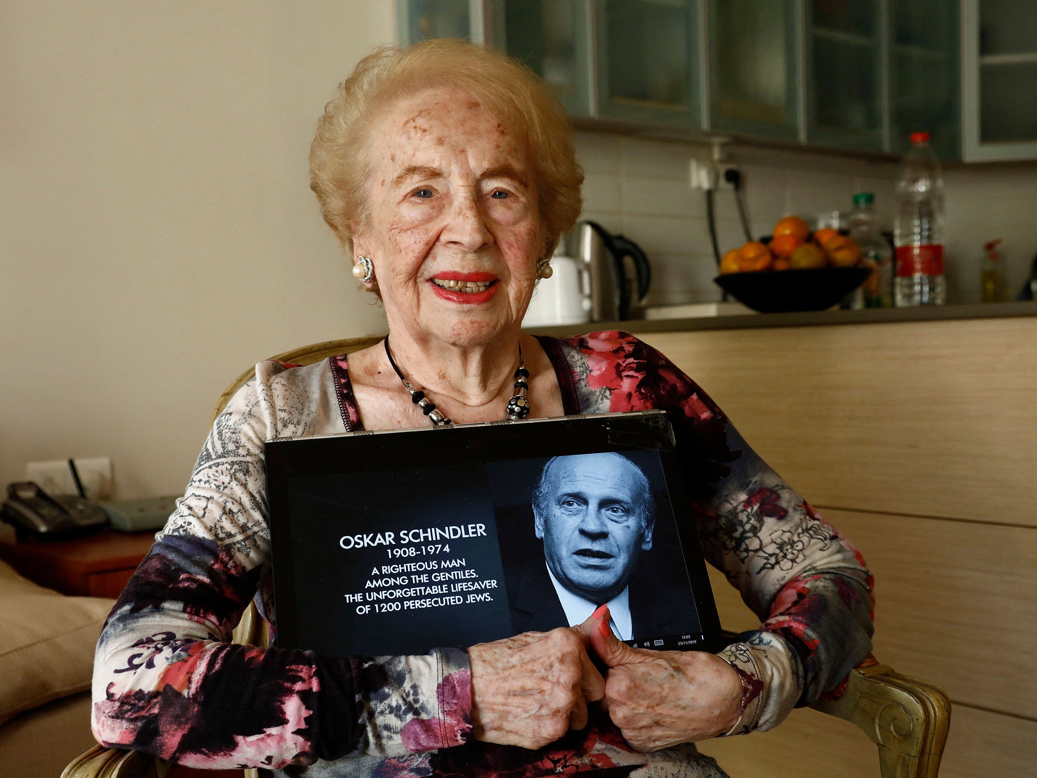 Reinhardt in 2019 with a photo of her old boss