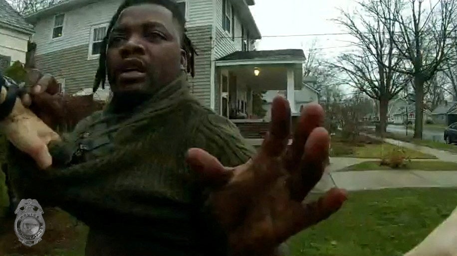 Grand Rapids Police officer grasps the shirt of Patrick Lyoya during a traffic stop, shortly before Lyoya was shot dead by the officer during a scuffle on a suburban front lawn in Grand Rapids, Michigan, U.S. April 4, 2022