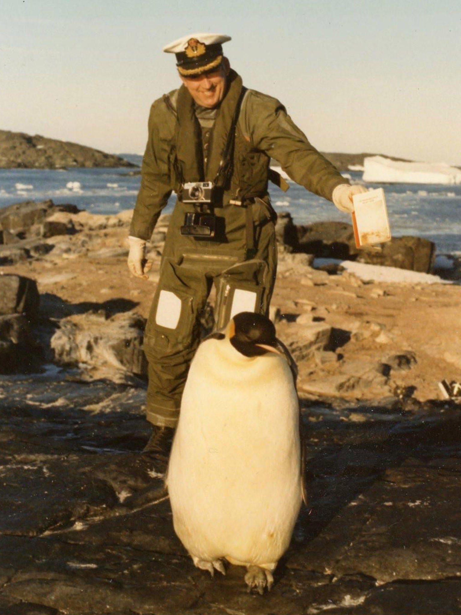 Capt Barker offers a copy of ‘Moby Dick’ to an emperor penguin in the Antarctic