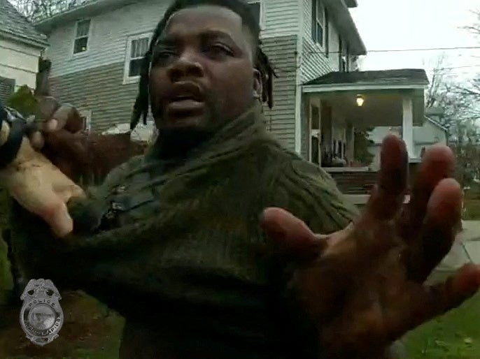 A Grand Rapids Police officer grasps the shirt of Patrick Lyoya during a traffic stop shortly before shooting him dead