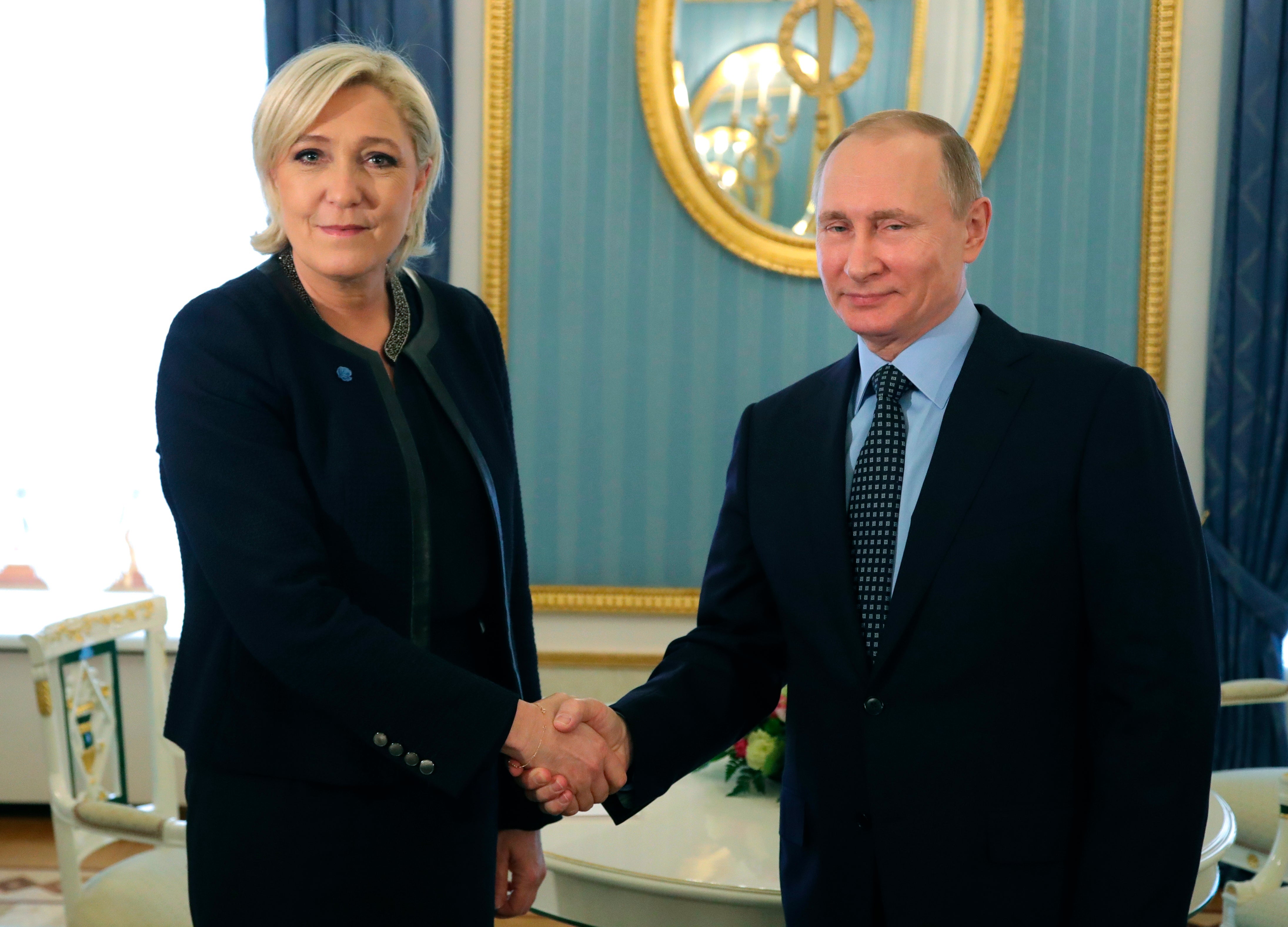 Vladimir Putin shakes hands with Marine Le Pen in the Kremlin in March 2017