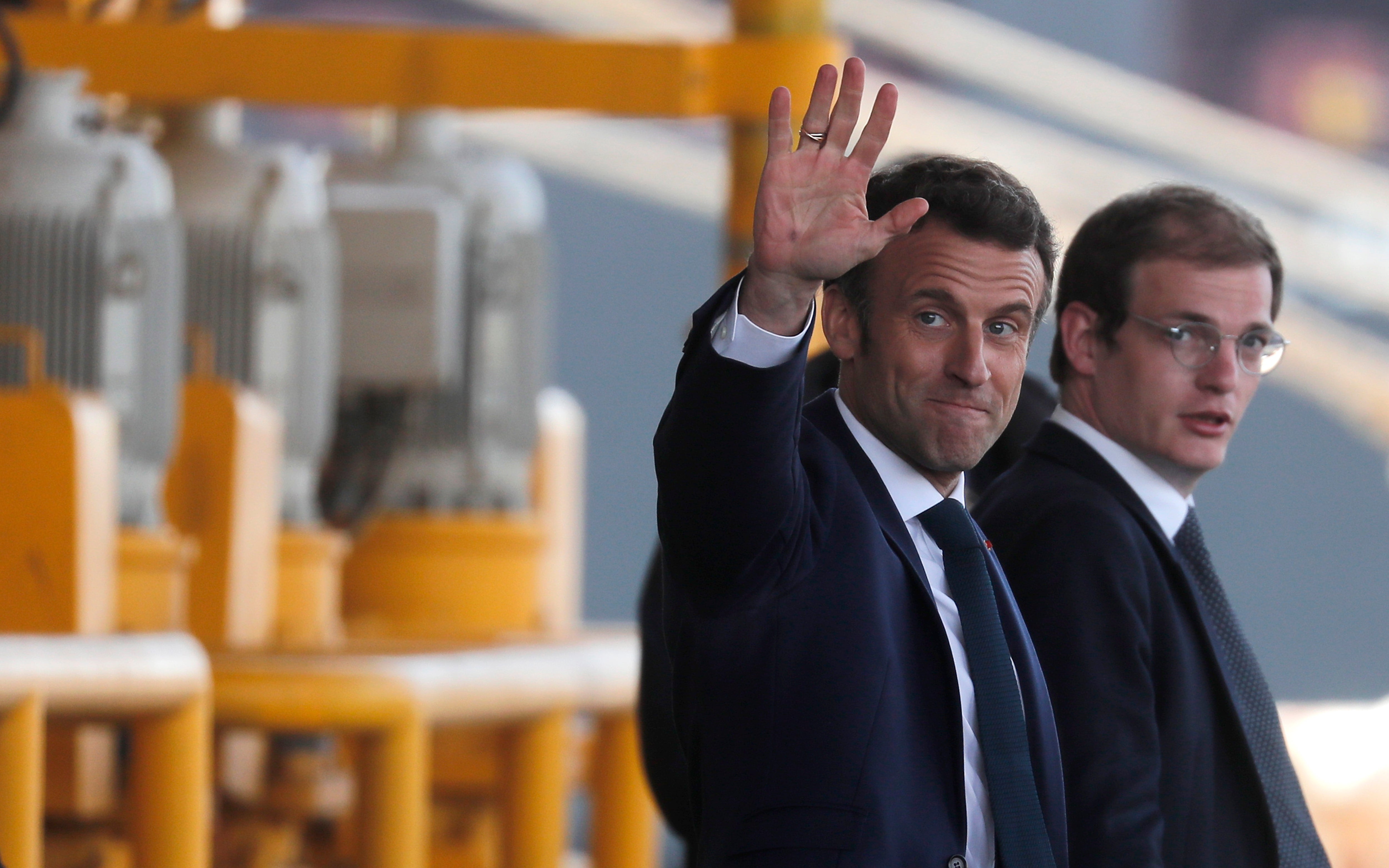 Incumbent French president and candidate for re-election Emmanuel Macron waves after a campaign stop at the port of Le Havre, France, on Thursday