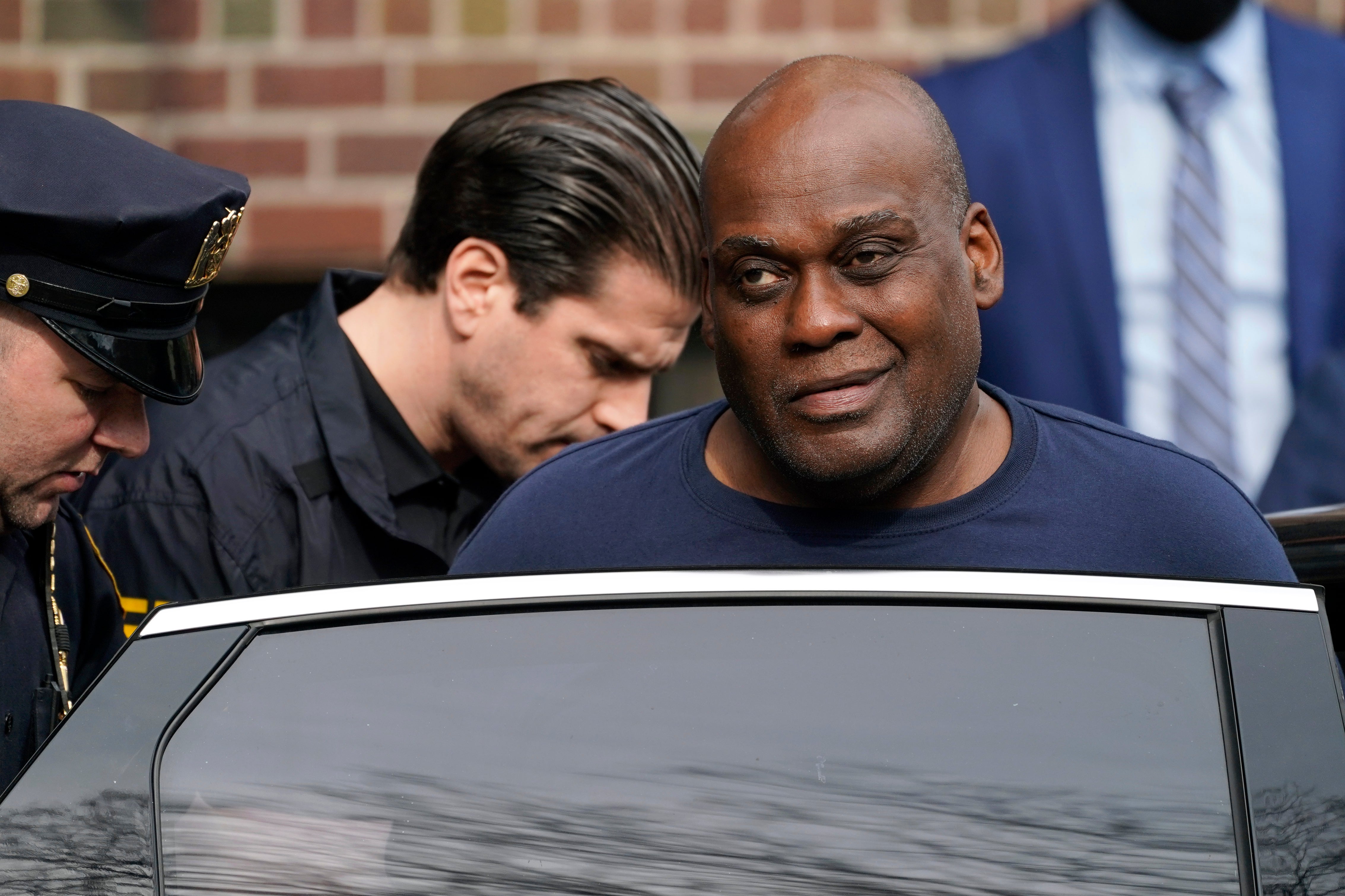 Frank James is led to a car from the 9th Precinct following his arrest