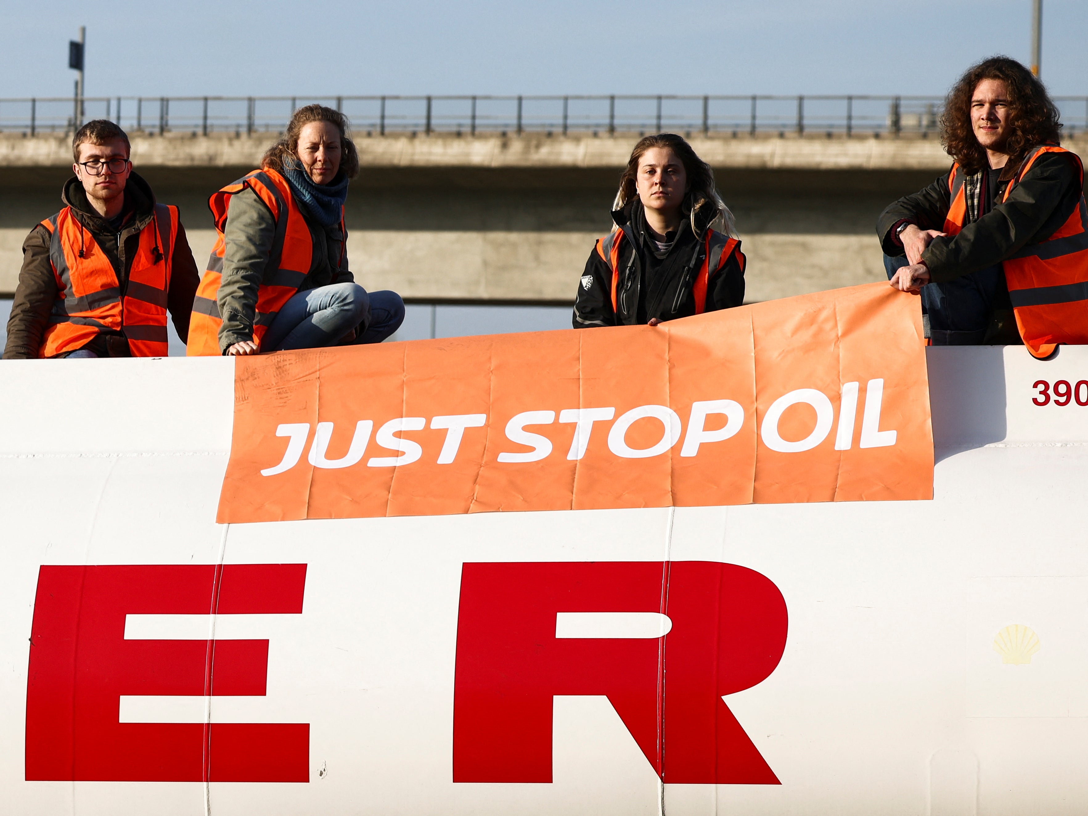 Activists from Just Stop Oil sit on top of a fuel tanker during a protest in Grays, Essex