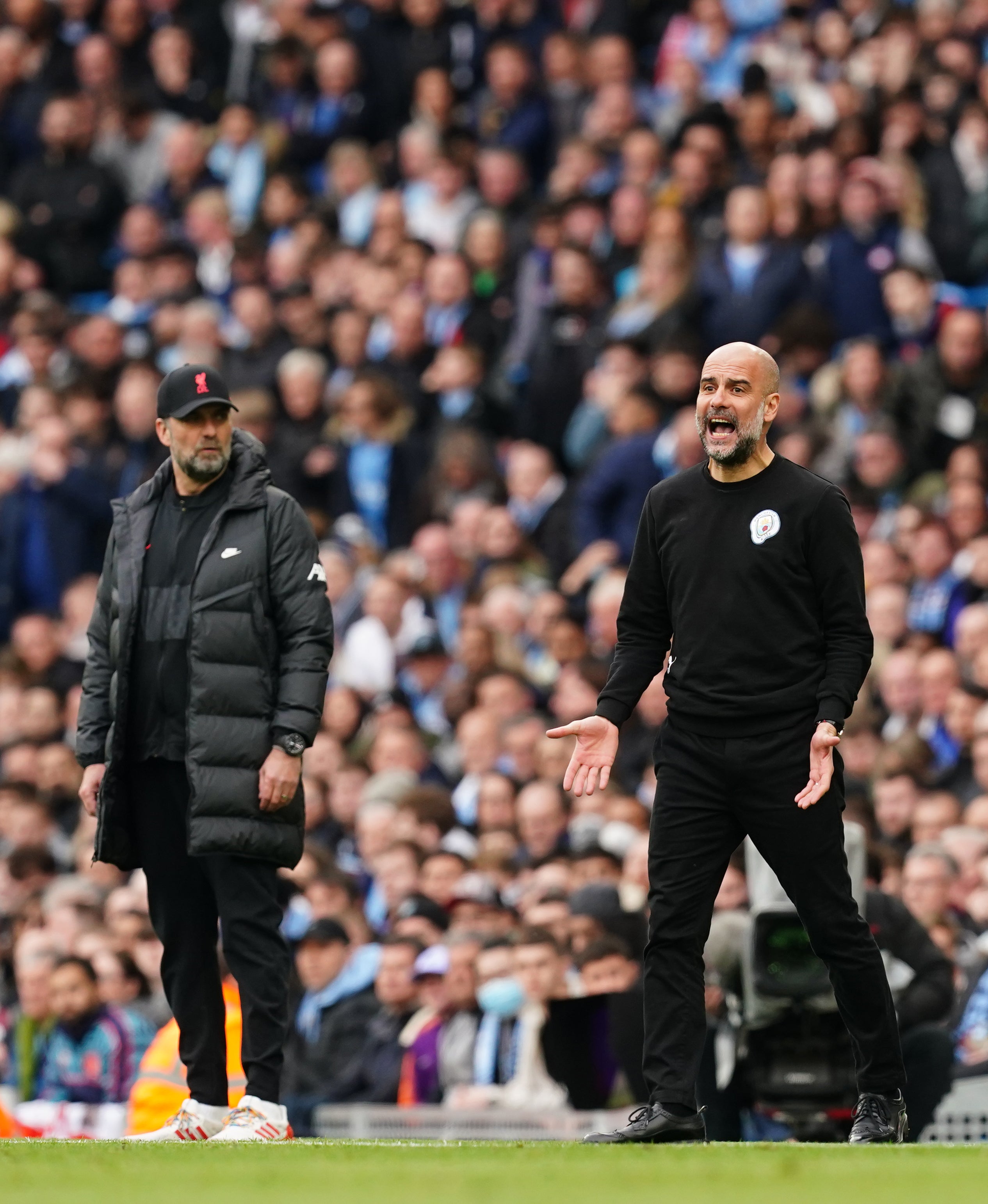 Guardiola (right) understands Liverpool boss Jurgen Klopp’s (left) frustrations with the schedule (Martin Rickett/PA)