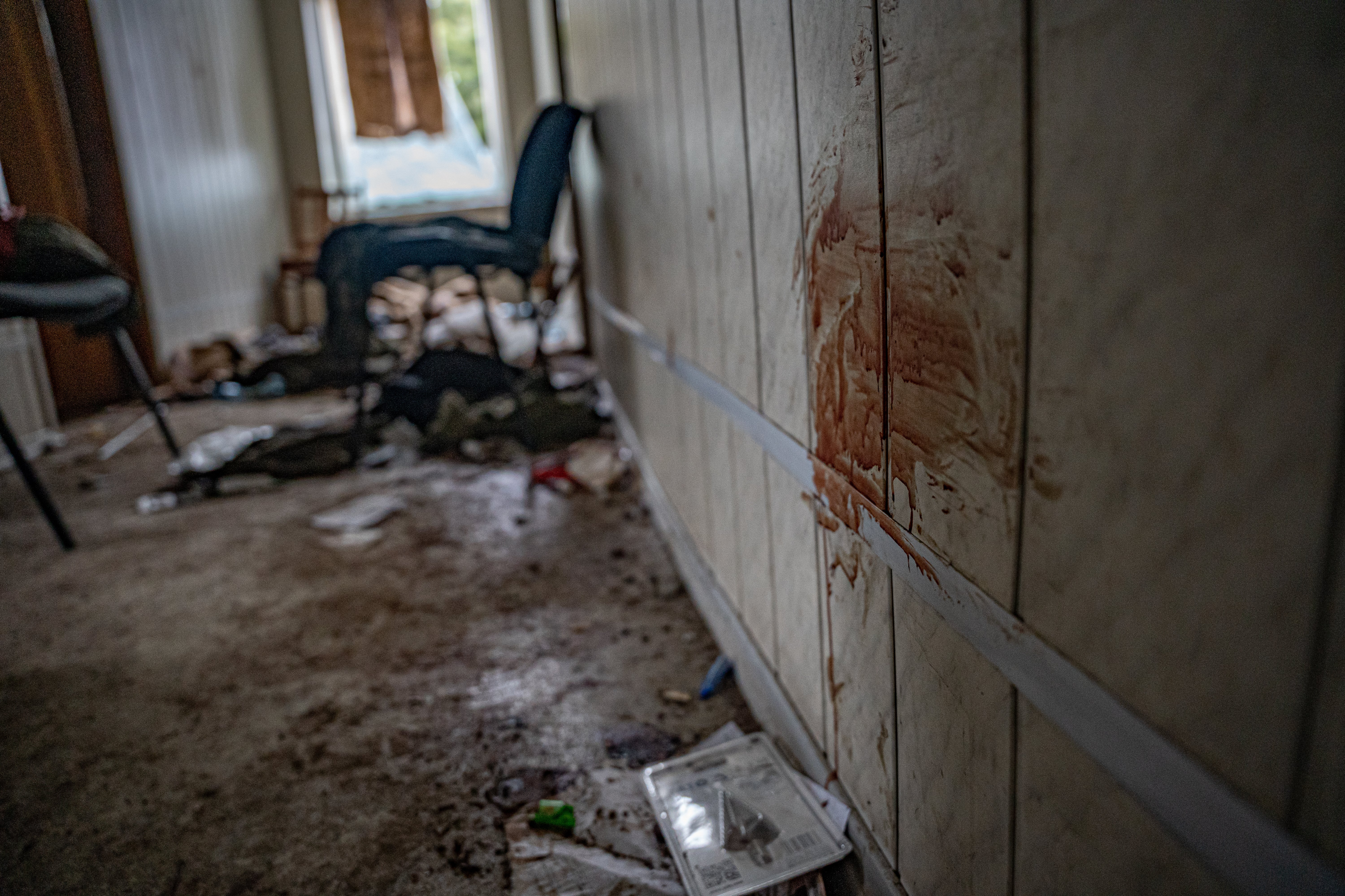 Blood smears the walls of the trashed administration building that the Russians used as a base in Trostyanets