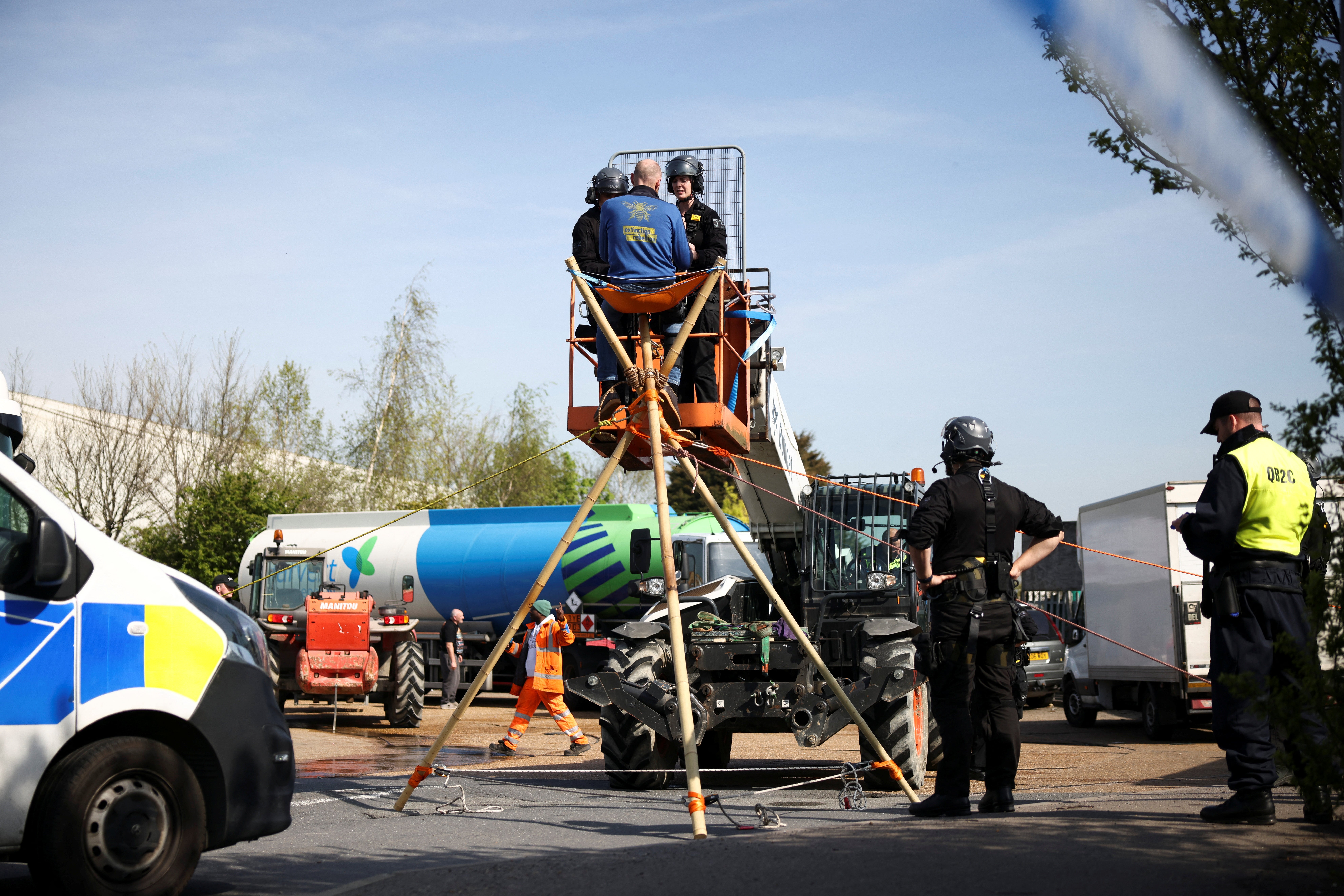 Activists from Just Stop Oil block an entrance to a fuel terminal, during a protest in Grays, Essex on 15 April