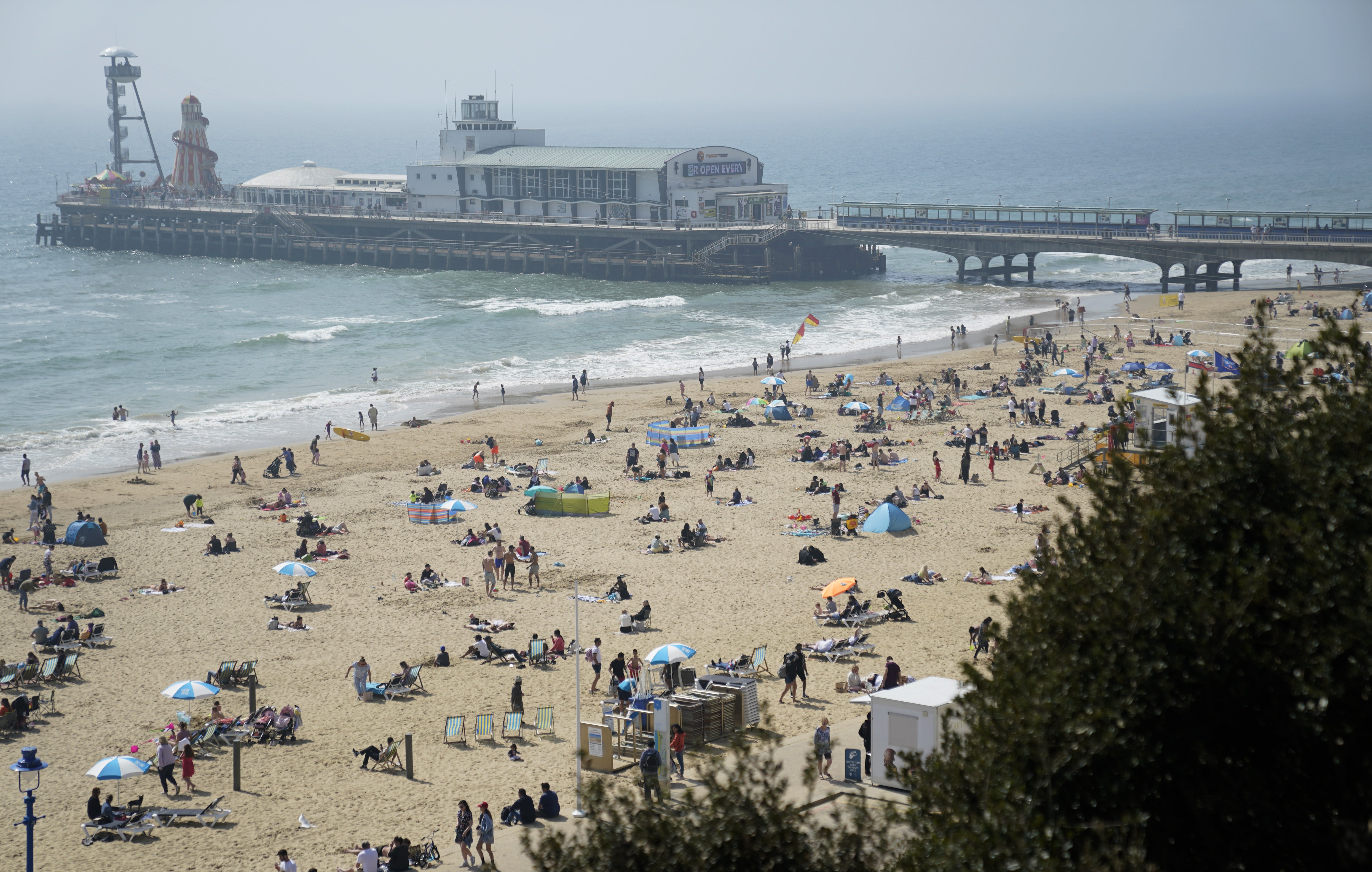 People enjoy the good weather at Bournemouth Beach in Dorset (Andrew Matthews/PA)