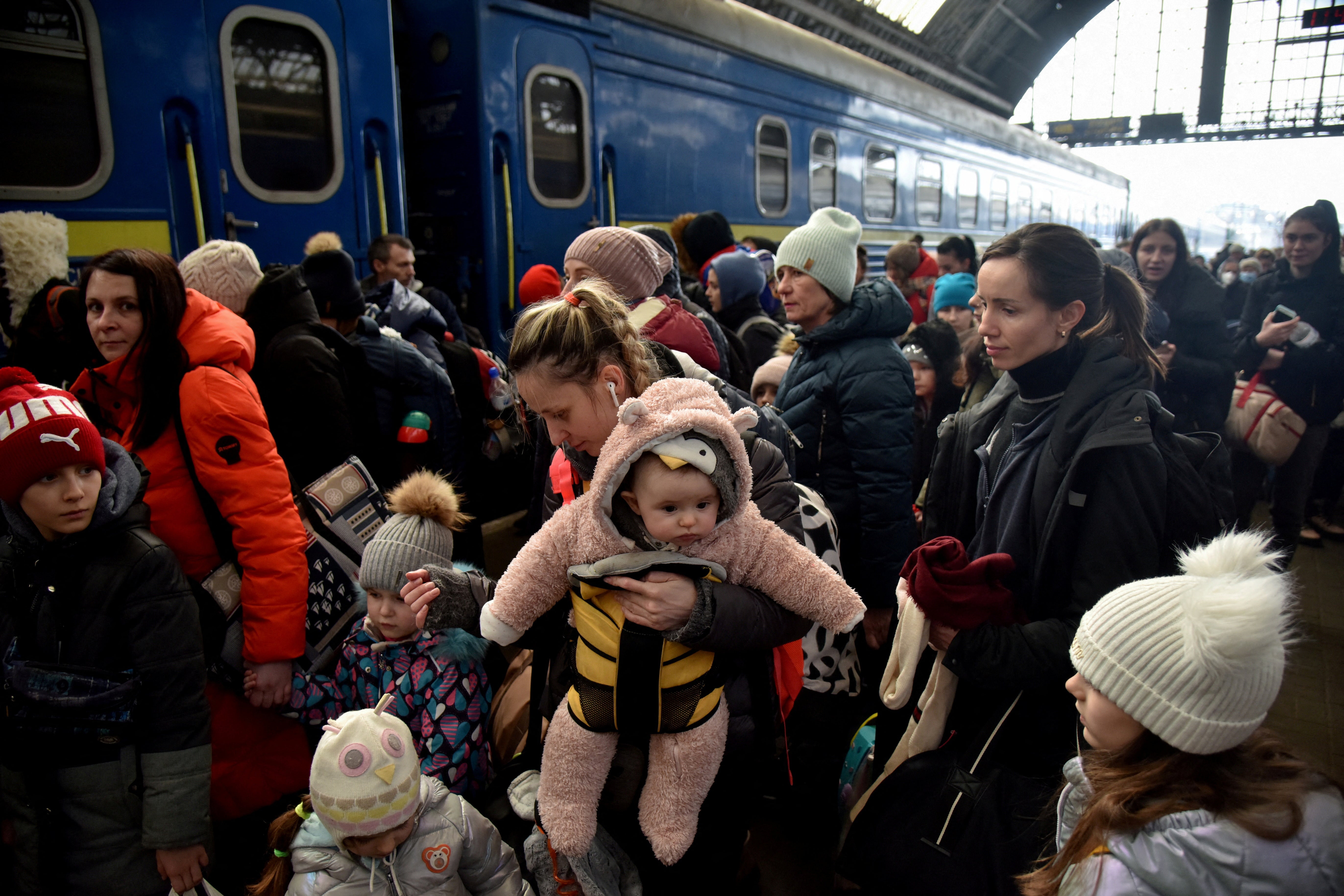 People fleeing Russia's invasion of Ukraine gather at the train station in Lviv, Ukraine