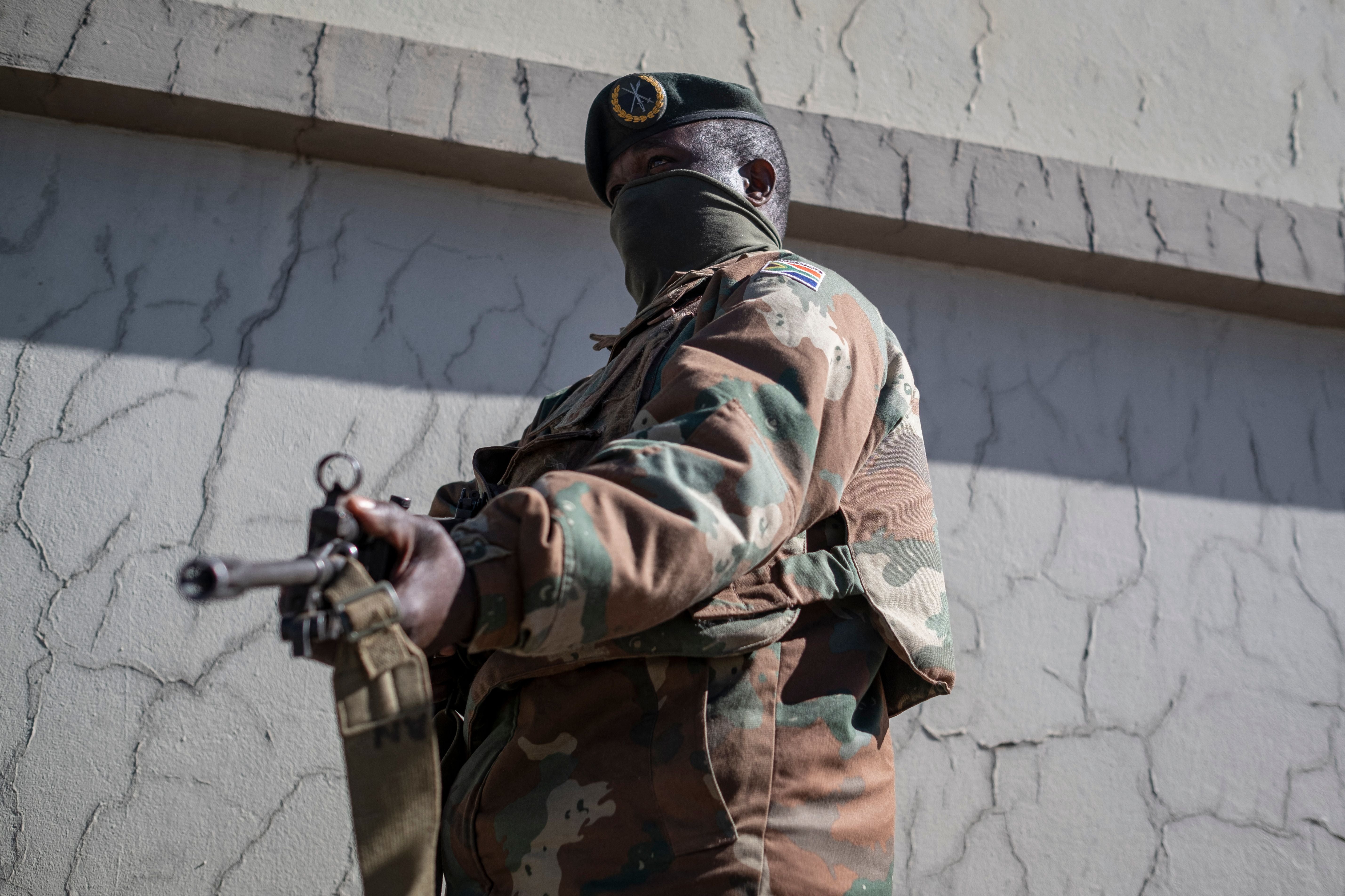 A South African National Defence Force (SANDF) soldier stands guard in Soweto, 13 July 2021