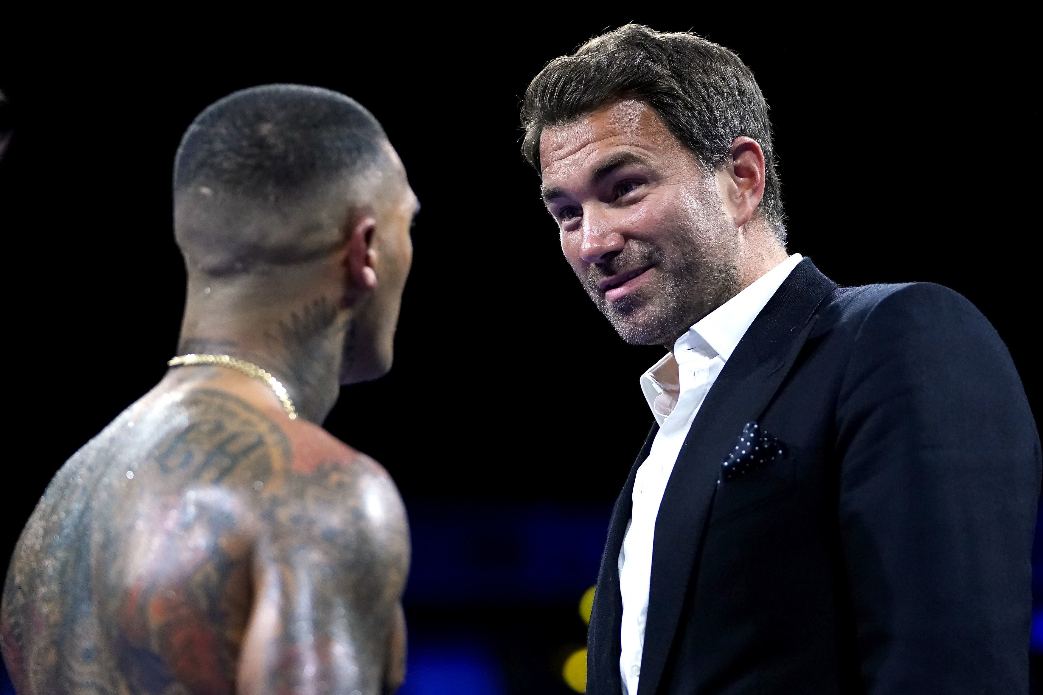 Benn talks to promoter Eddie Hearn in the ring after beating Van Heerden