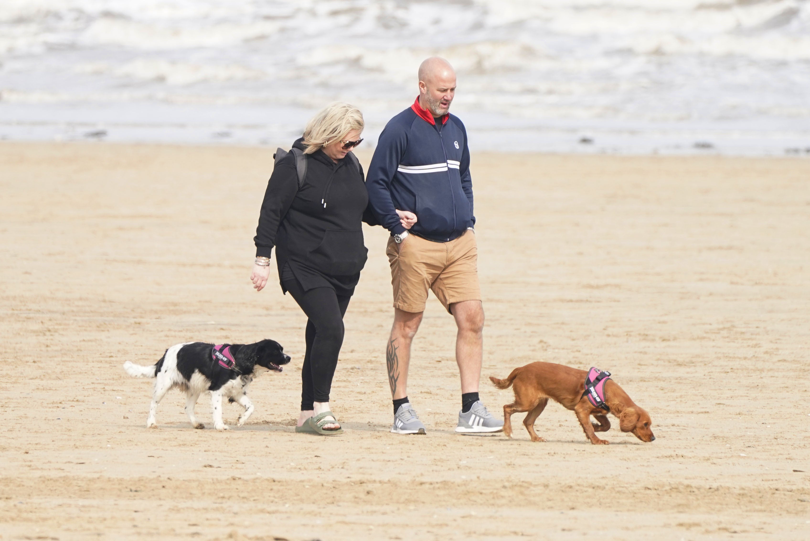 People walking dogs on Bridlington Beach in Yorkshire (Danny Lawson/PA)