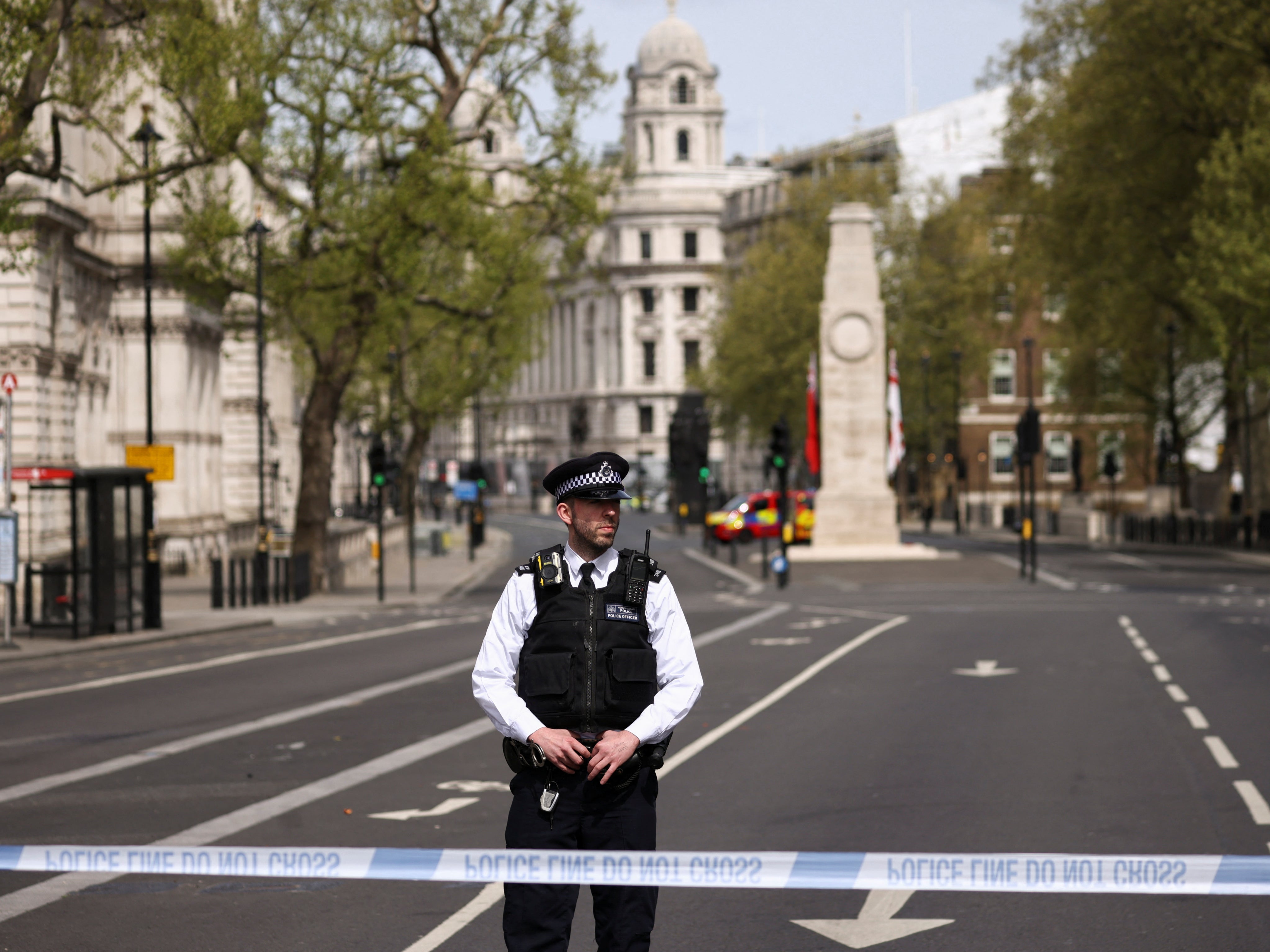 A police officer stands at a cordon on Whitehall in Westminster after the road was closed following the incident