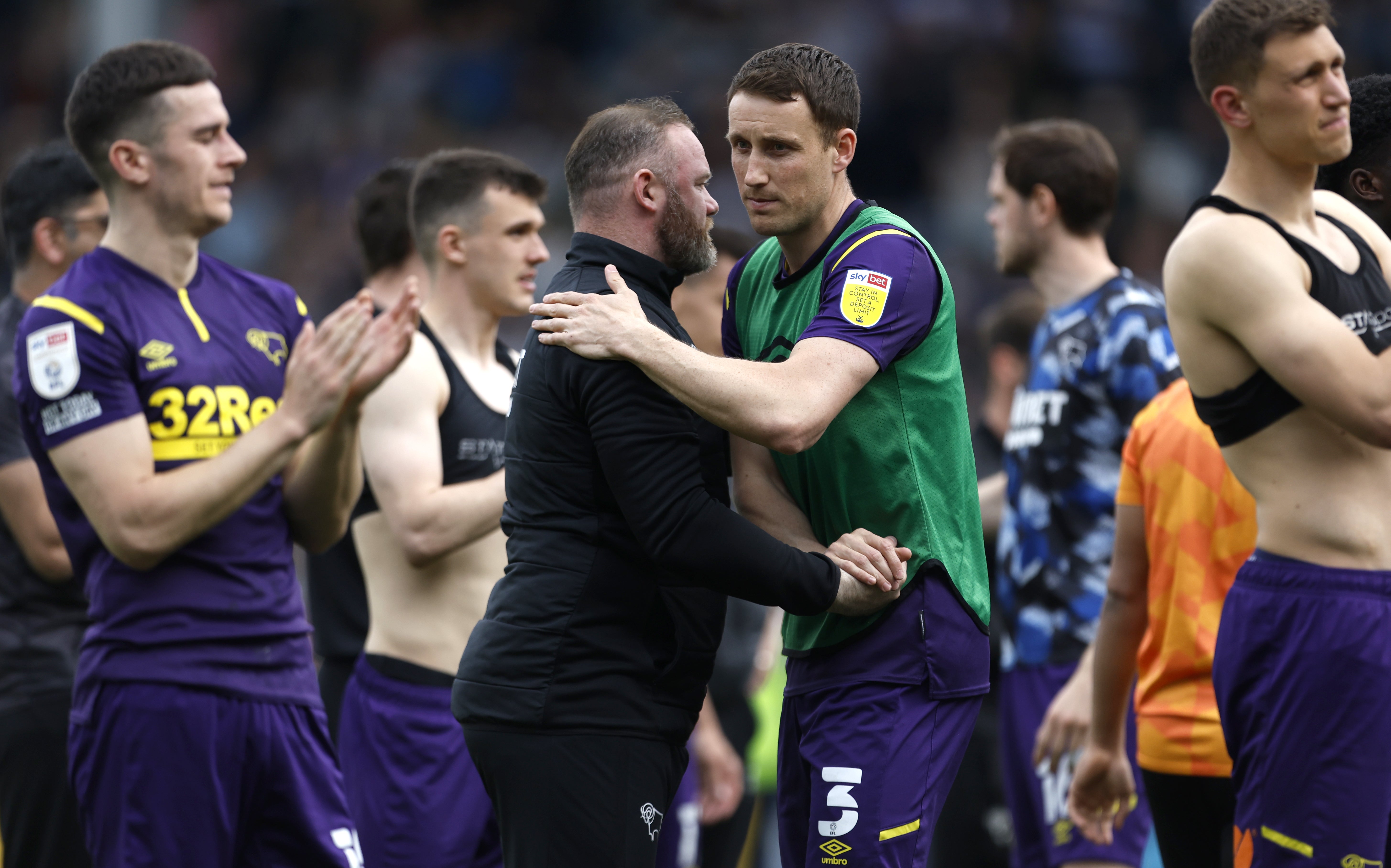 Wayne Rooney consoles his players following the defeat to QPR (Steven Paston/PA).