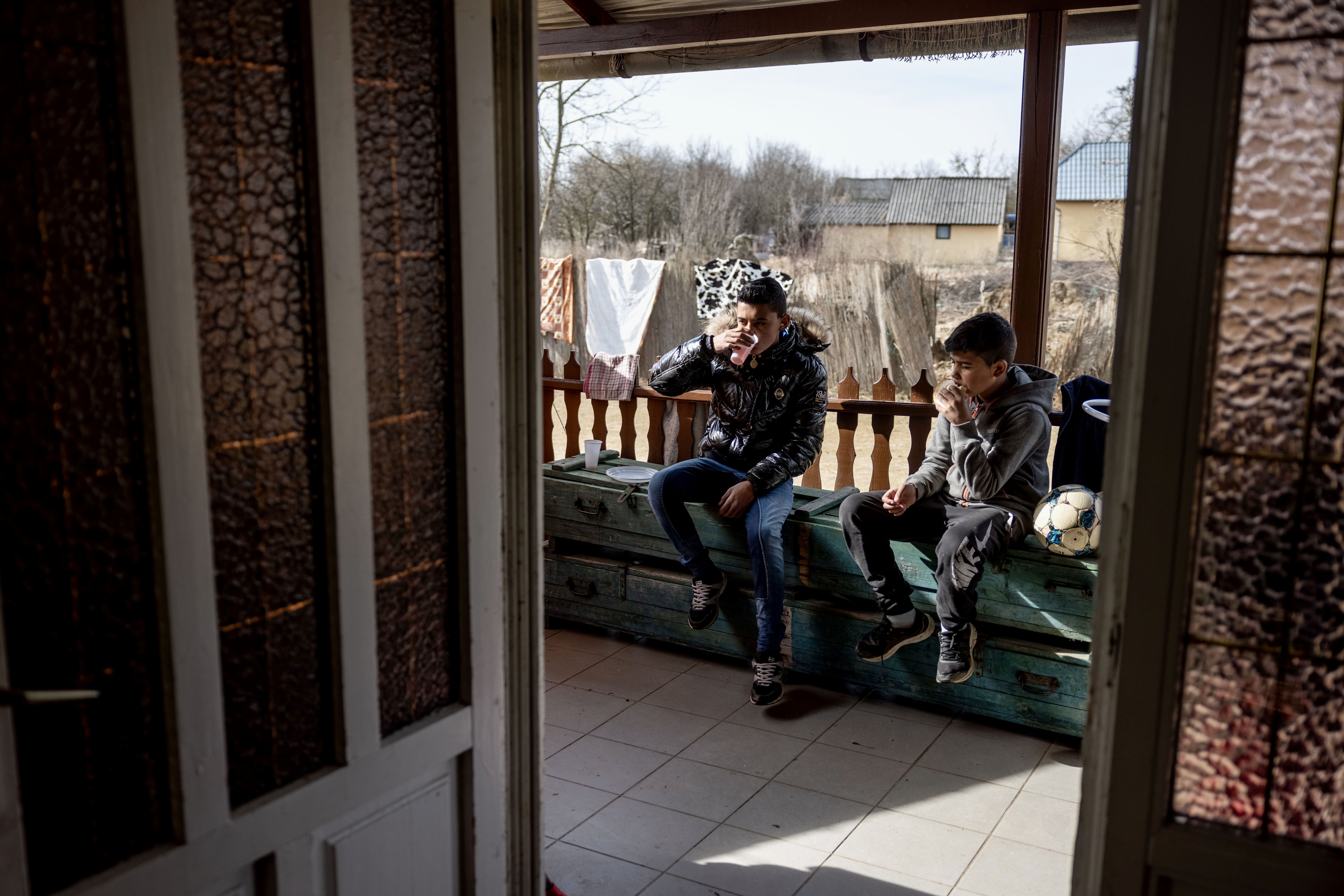 Refugee boys have breakfast at a temporary shelter