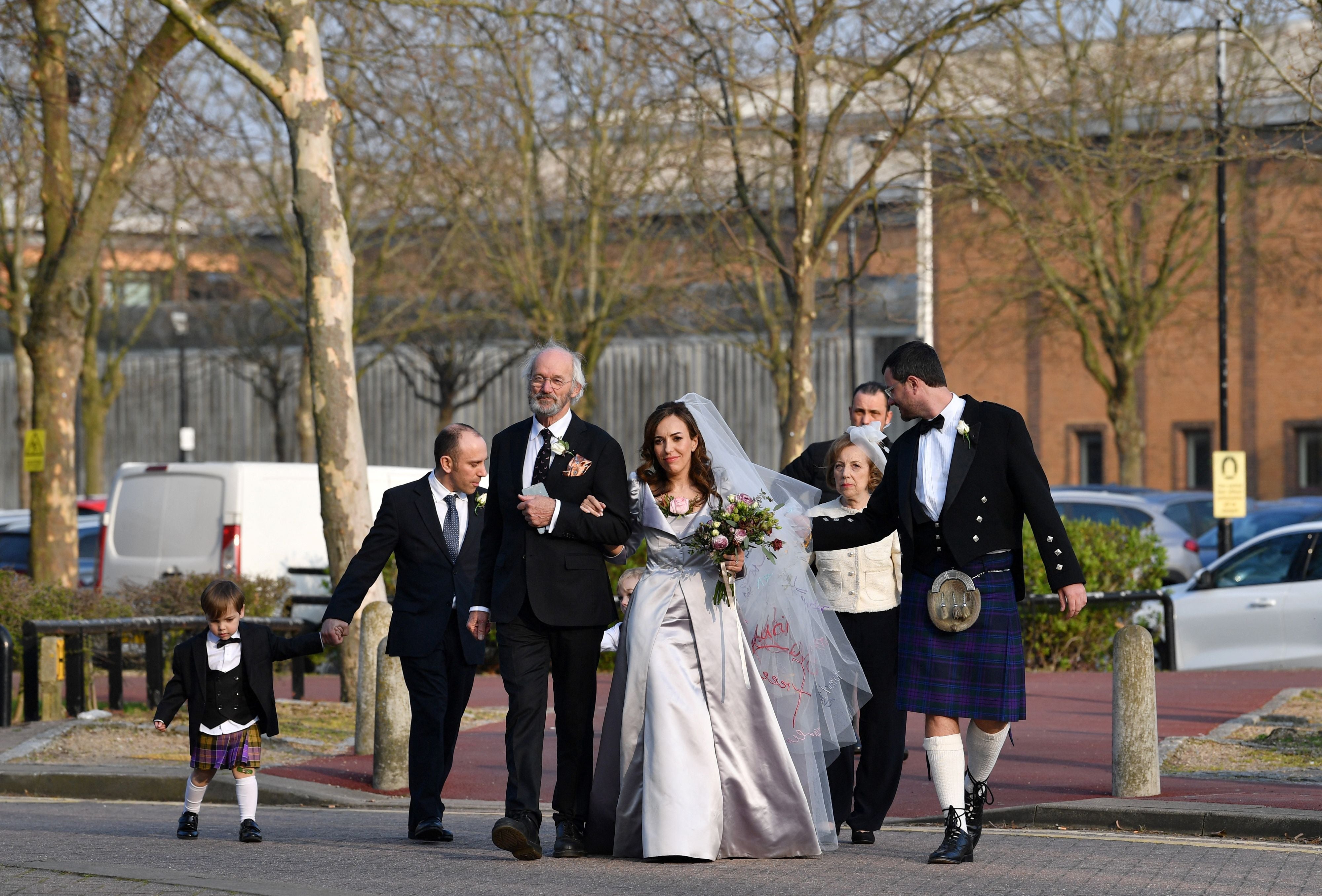 John Shipton, father of WikiLeaks founder Julian Assange, walks with his son's partner Stella Moris as they leave from Belmarsh Prison in London, on March 23, 2022, where Moris was set to marry Julian Assange