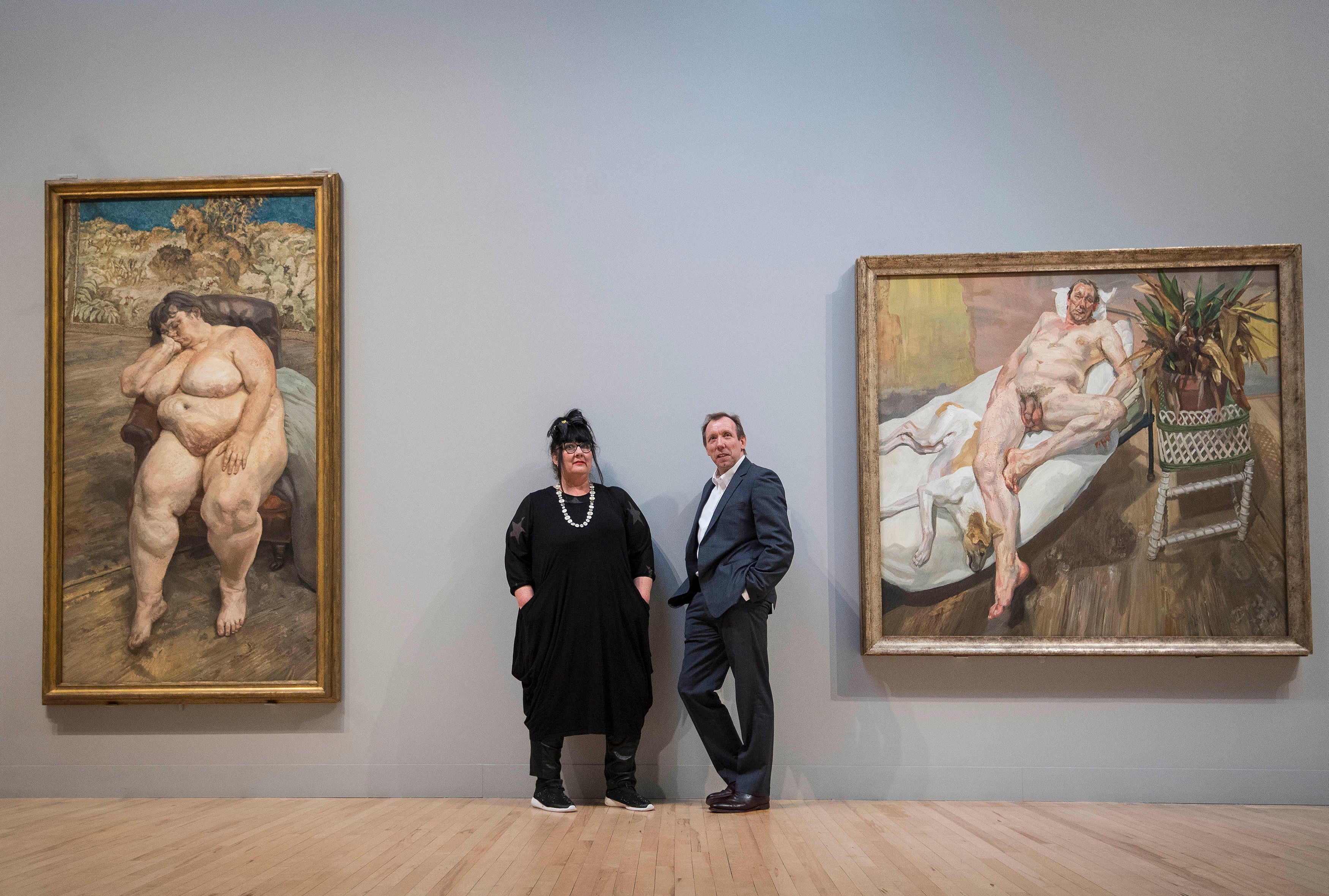 Sue Tilley and David Dawson in front of their portraits entitled ‘Sleeping by the Lion Carpet’ (left) and ‘David and Eli’