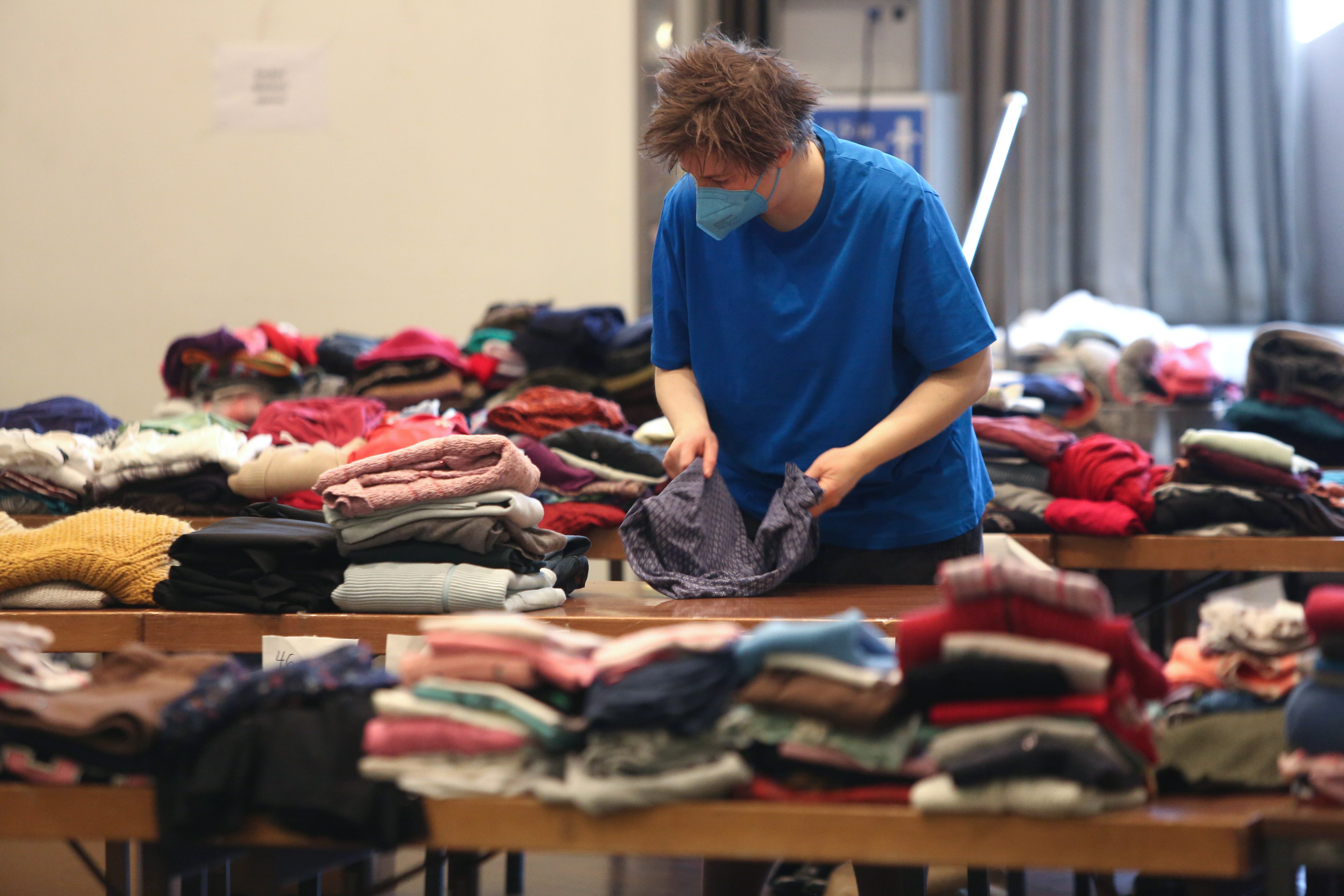 A volunteer helps sort donated clothing for Jewish refugees from Ukraine in Berlin