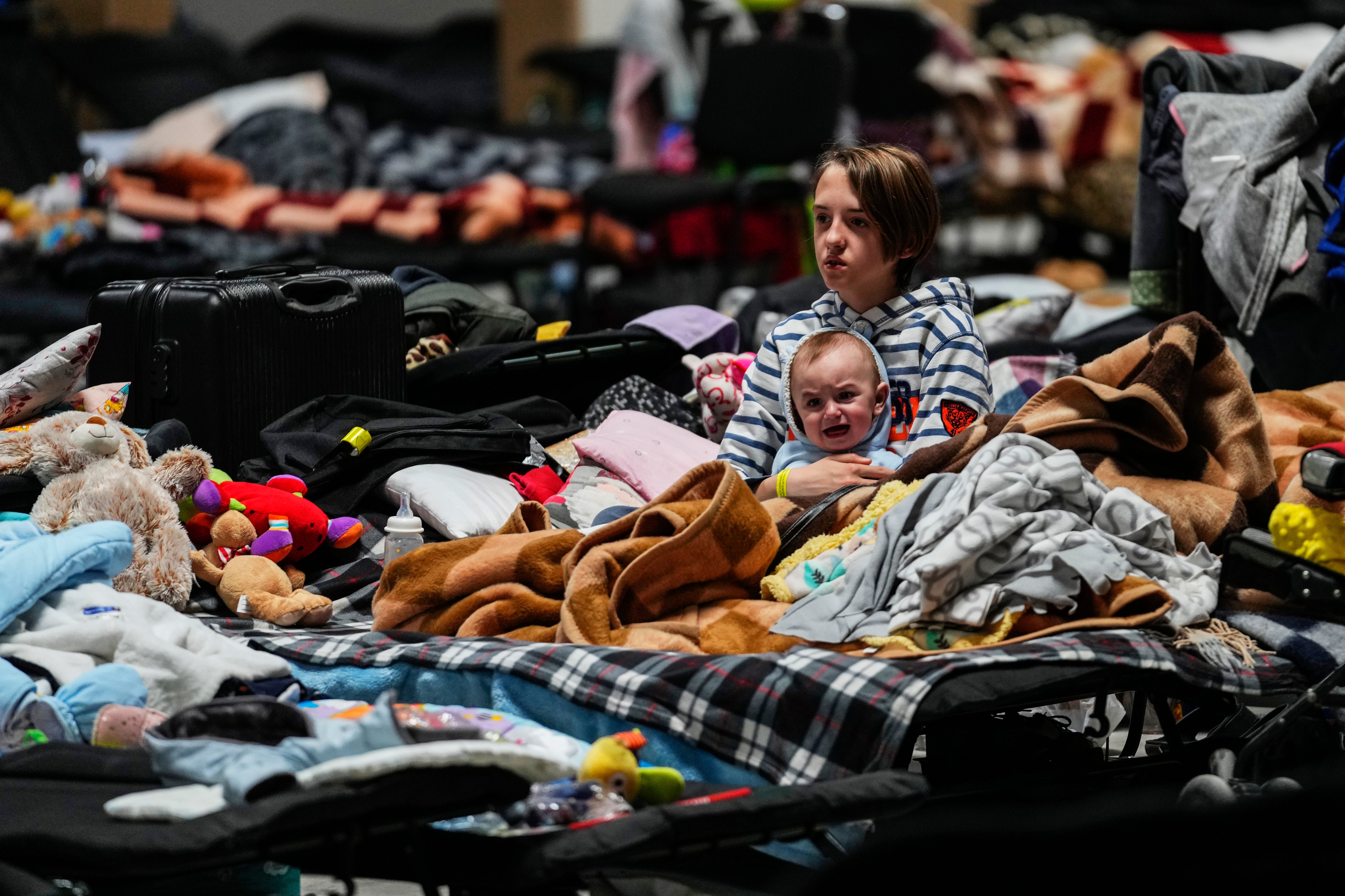 Children sit in a refugee center in Nadarzyn, near Warsaw, Poland