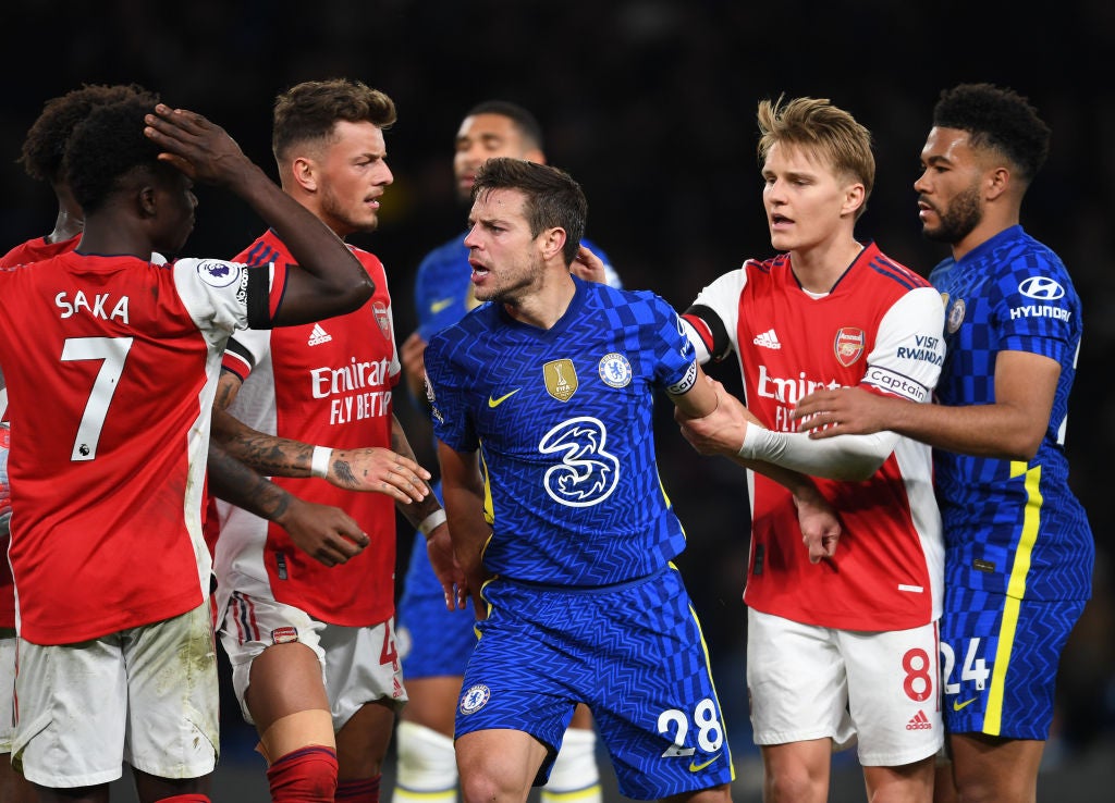 Arsenal's Bukayo Saka is confronted by Cesar Azipilicueta