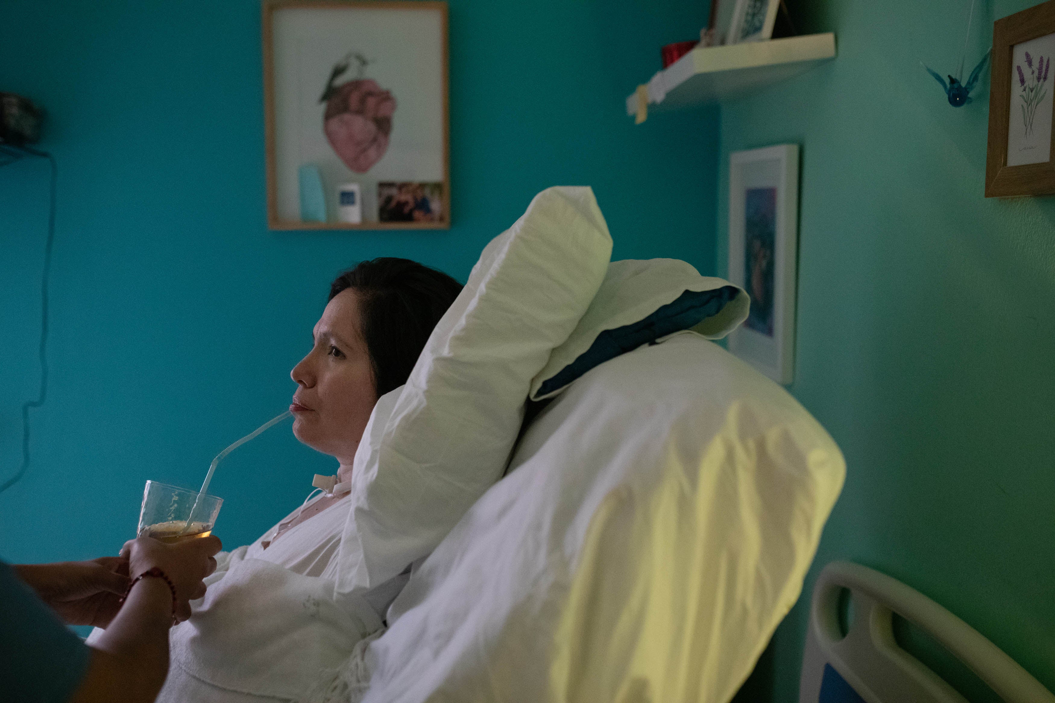 One of her nurses helps Estrada with her lunch