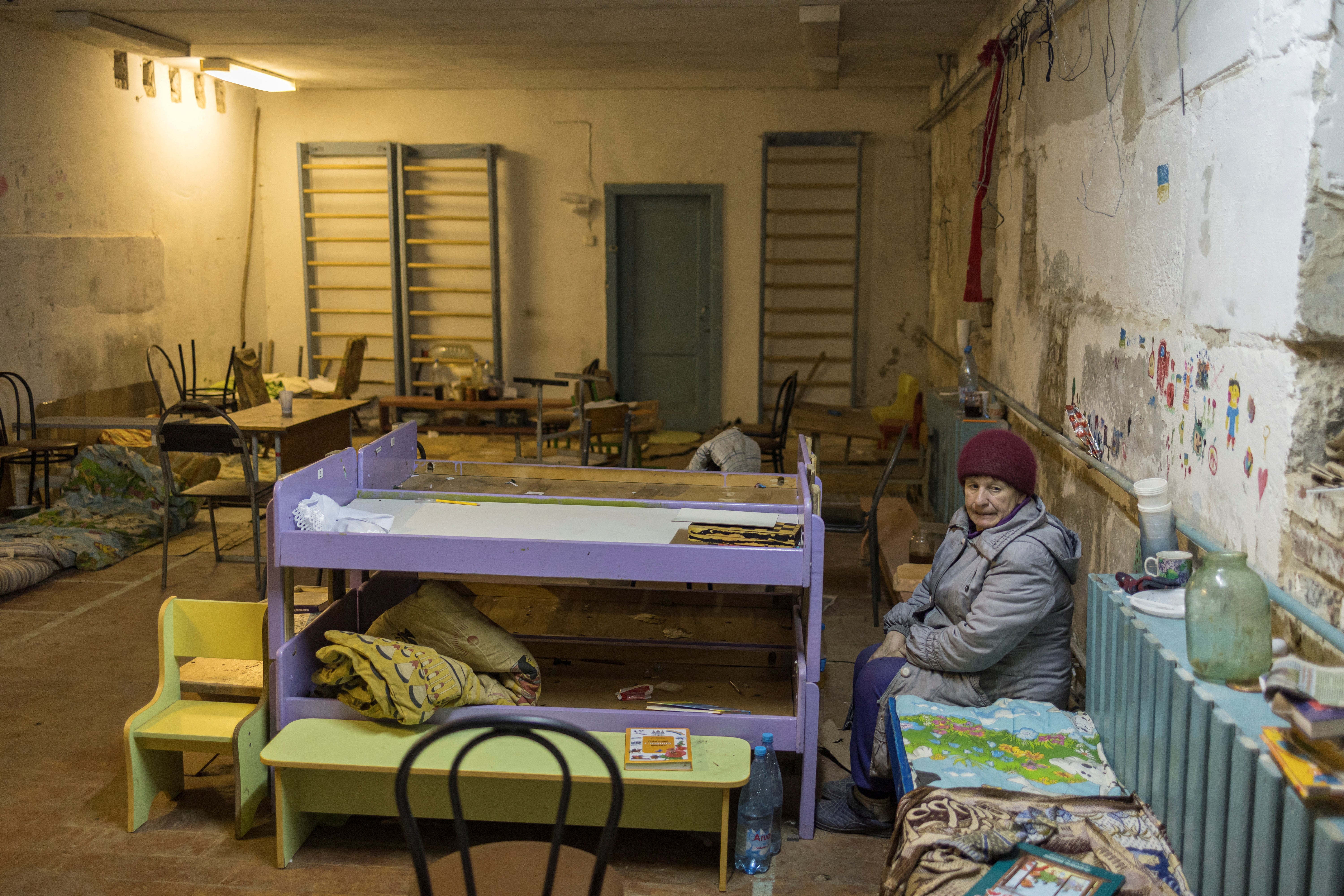 Tamara Klymchuk, 64, sits inside the basement of the school