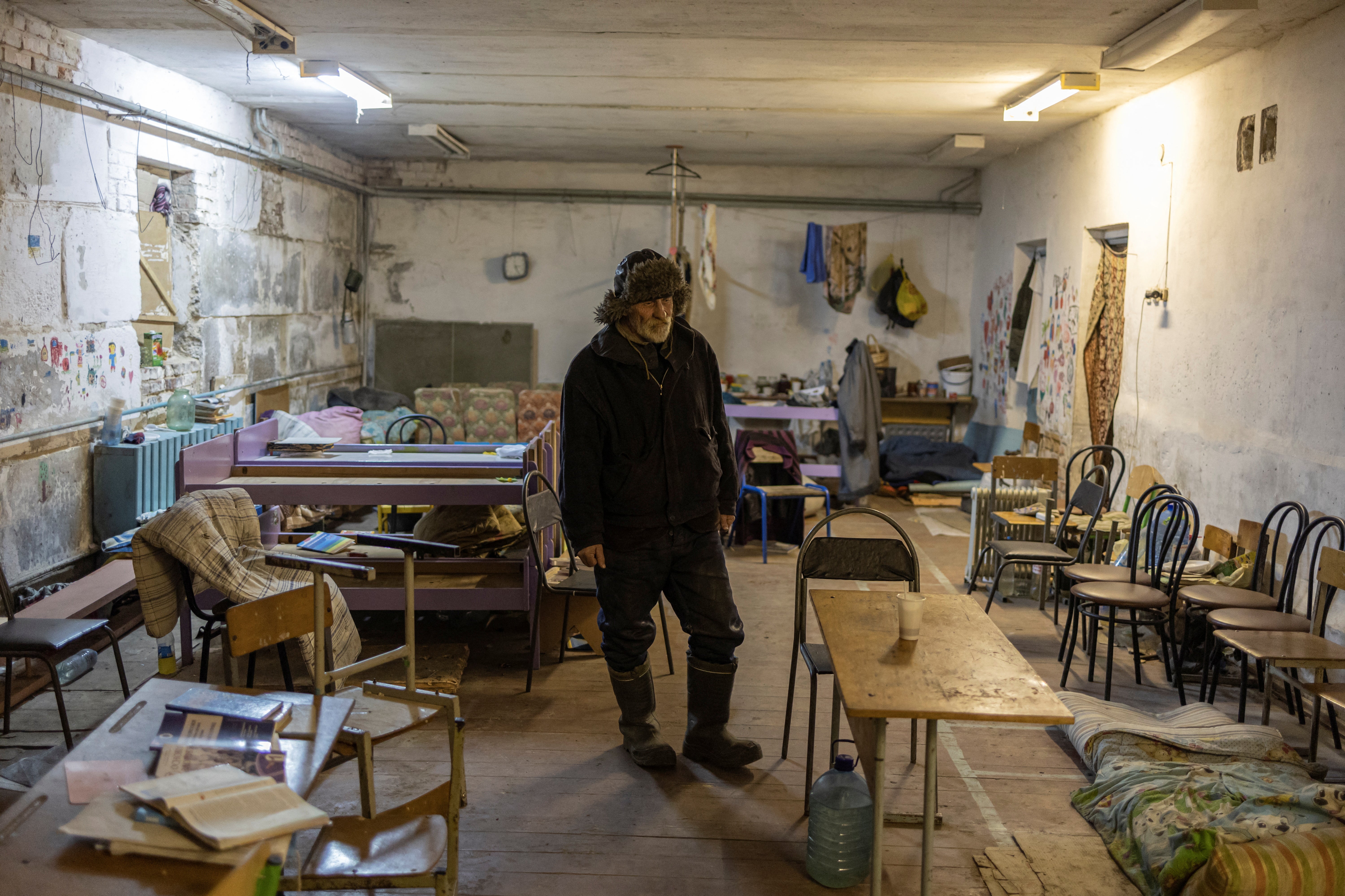 Ivan Balanovych stands inside the basement of the school