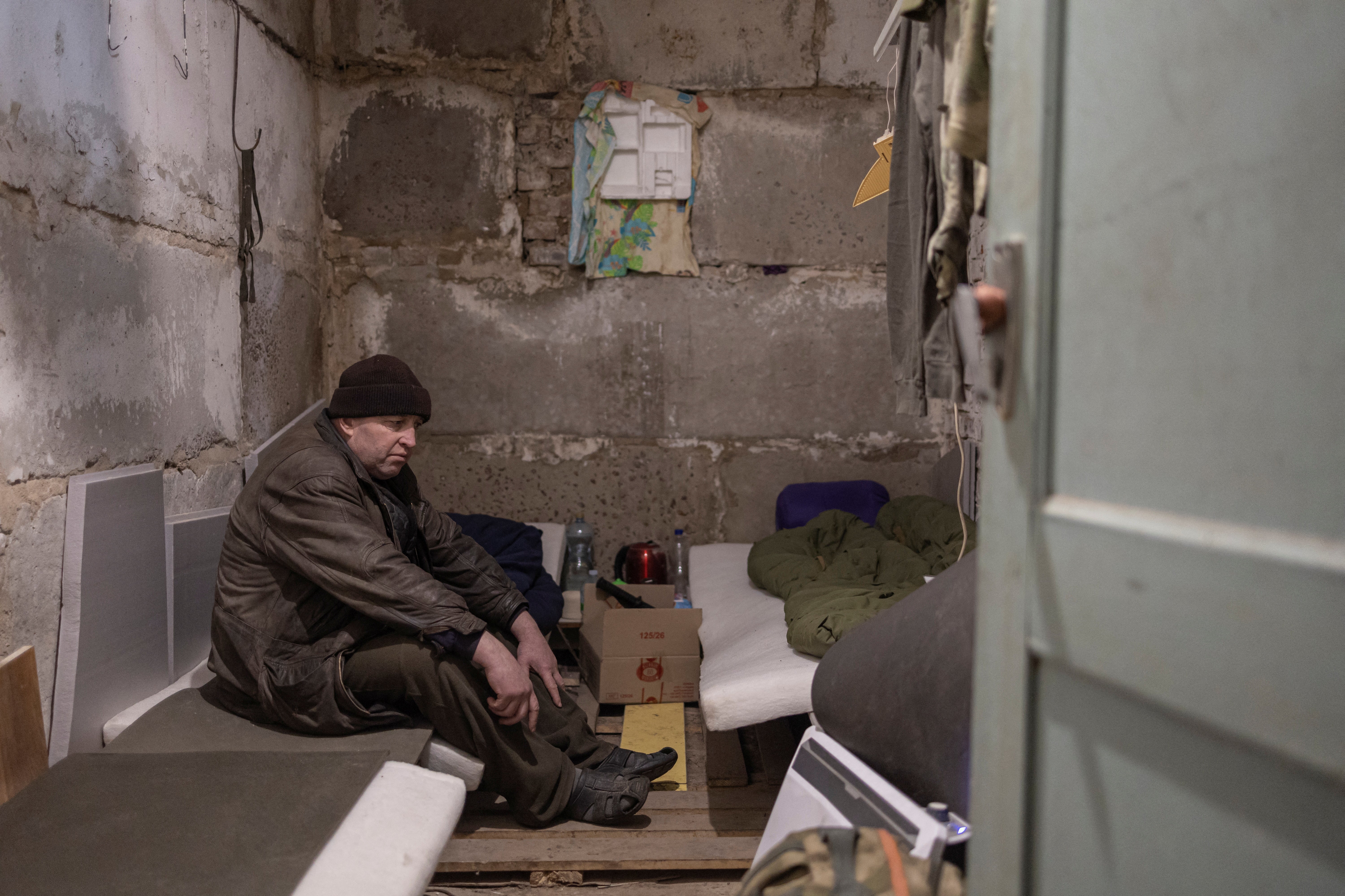 Serhii Bondarenko sits inside a room in the basement of the school