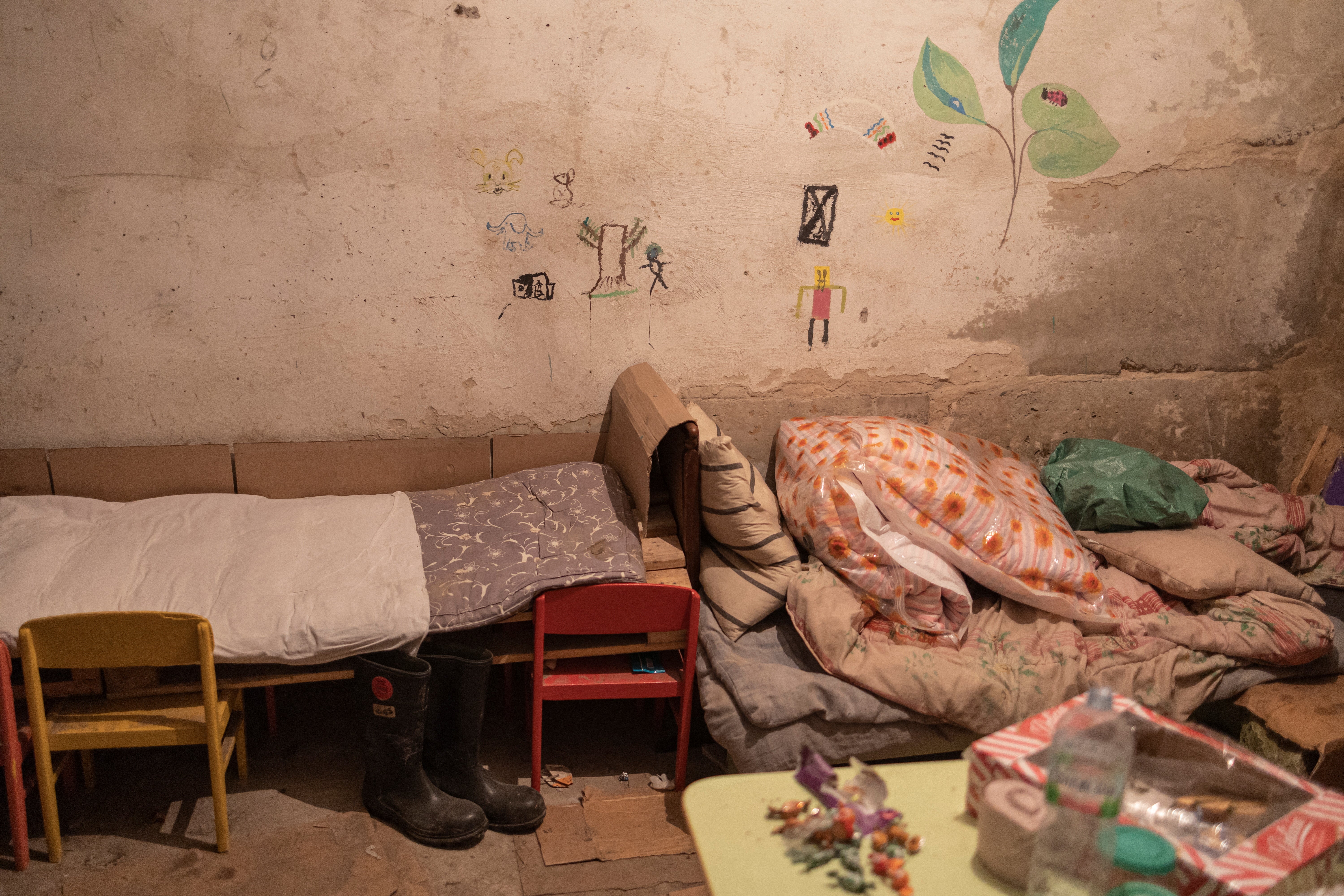 Improvised beds are seen inside the basement of a school