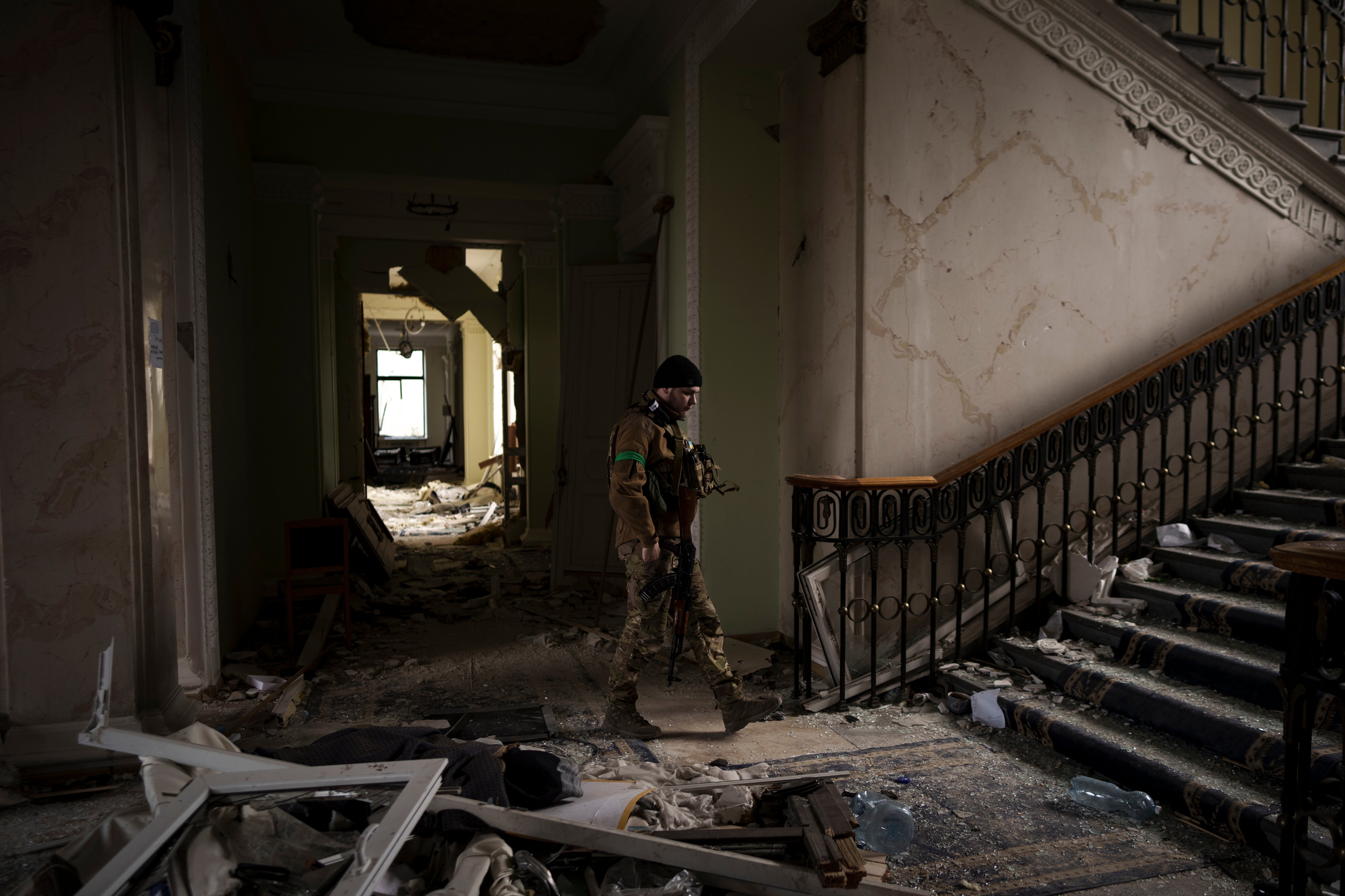 A soldier walks inside the regional administration building in Kharkiv that was heavily damaged in a Russian attack