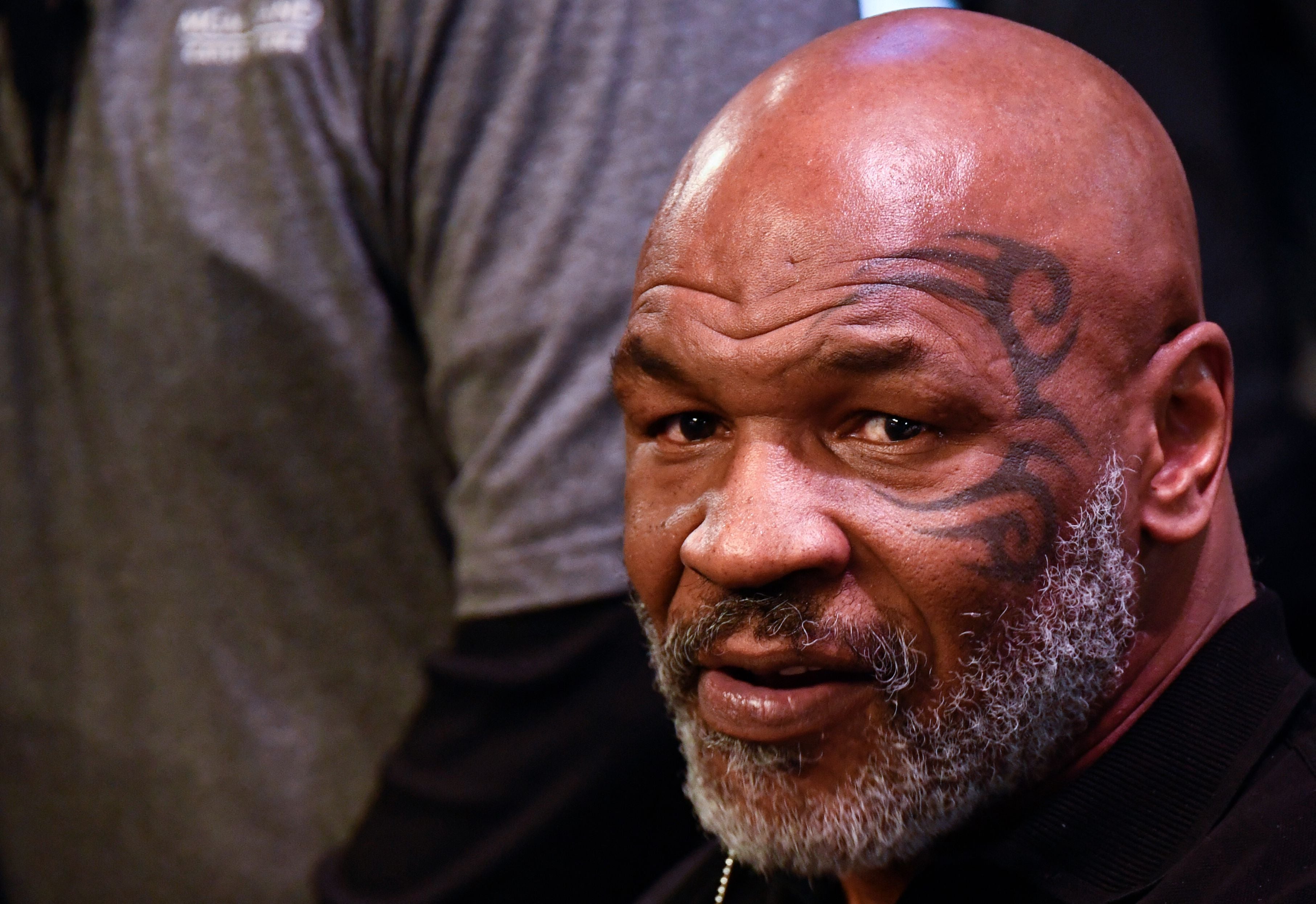 In video footage taken on a plane, the boxer is seen reaching over his seat to the man sitting behind him, before taking multiple swings at him