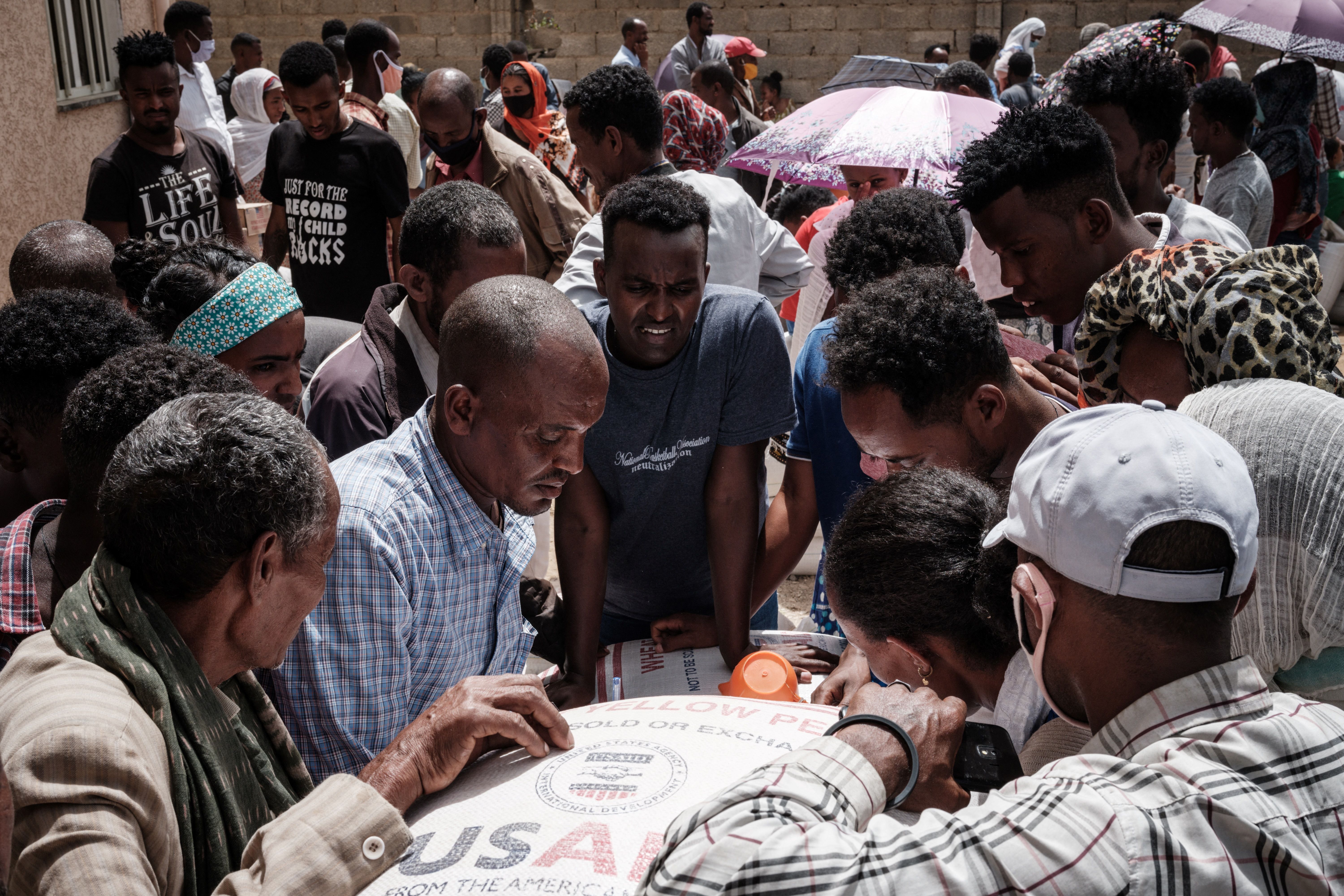 People who fled violence in Ethiopia’s Tigray region gather to receive aid in Mekele, 22 June 2021