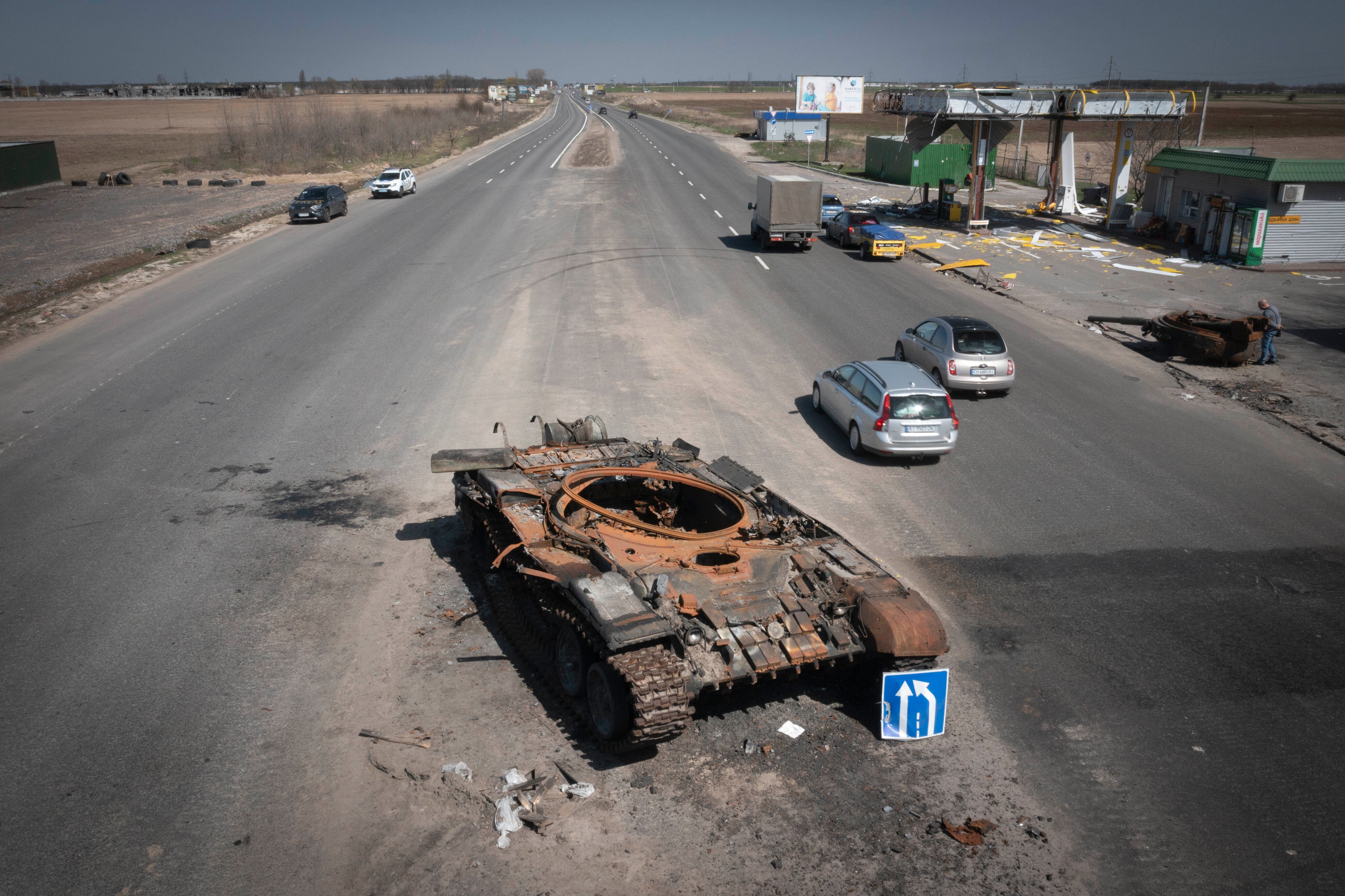 A Russian tank destroyed in recent fighting is seen on a road to Kyiv