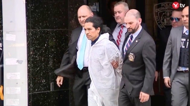 David Bonola is escorted out of the 112th police precinct after allegedly confessing to the crime