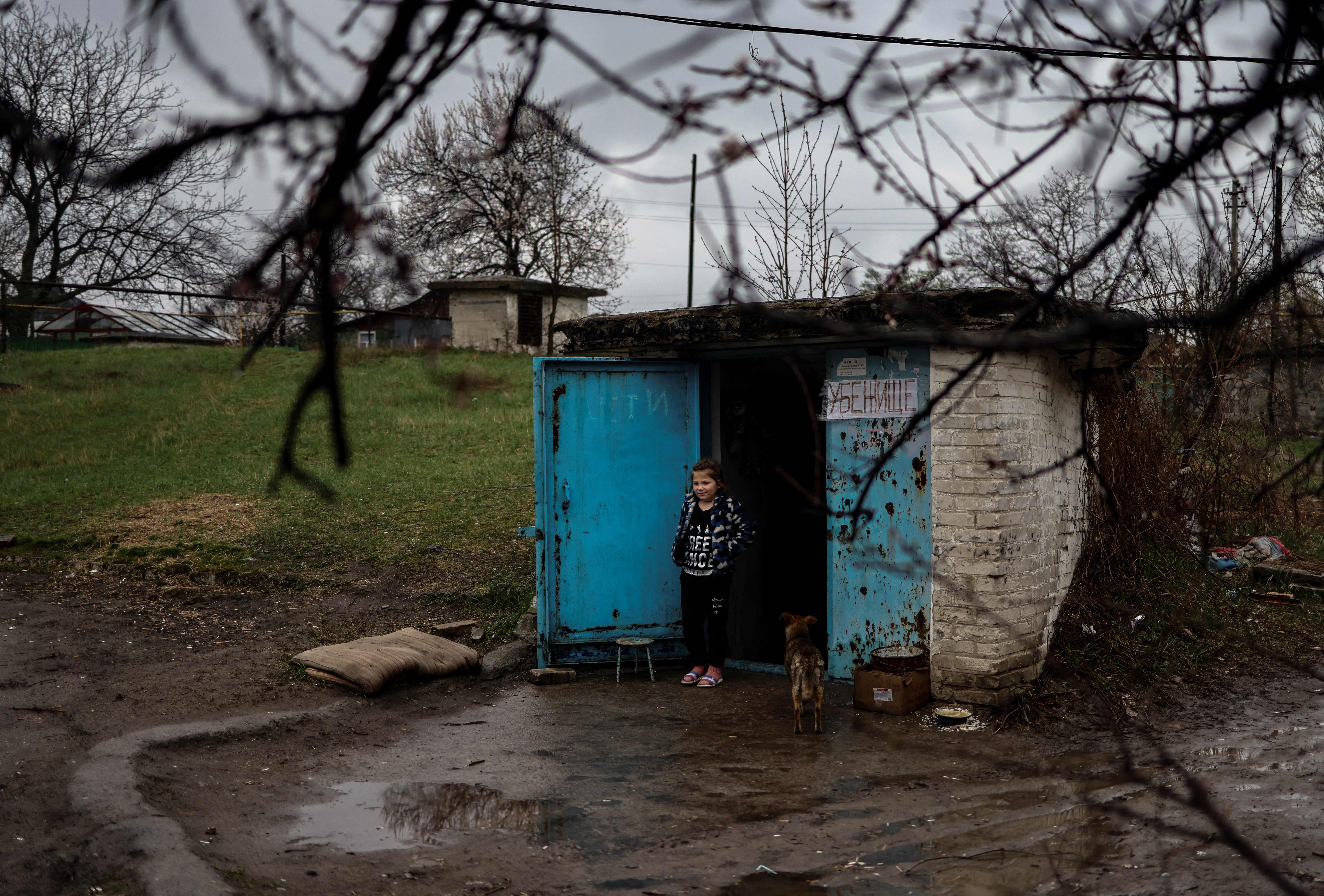 A girl stands by the door of a bunker in Severodonetsk, in eastern Ukraine’s Donbas region, on 13 April 2022