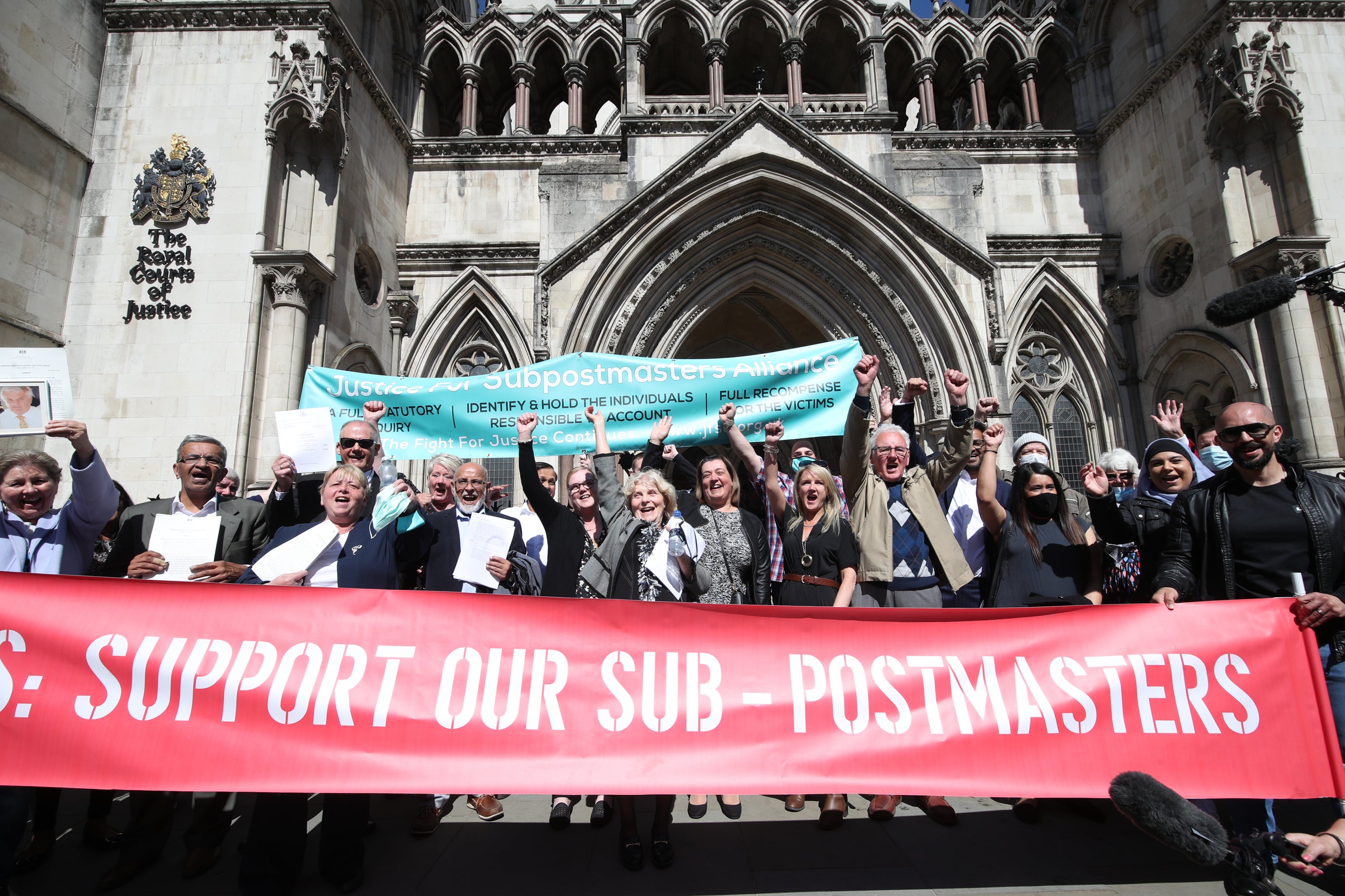 Former post office workers celebrate outside the Royal Courts of Justice, London, after having their convictions overturned (PA)