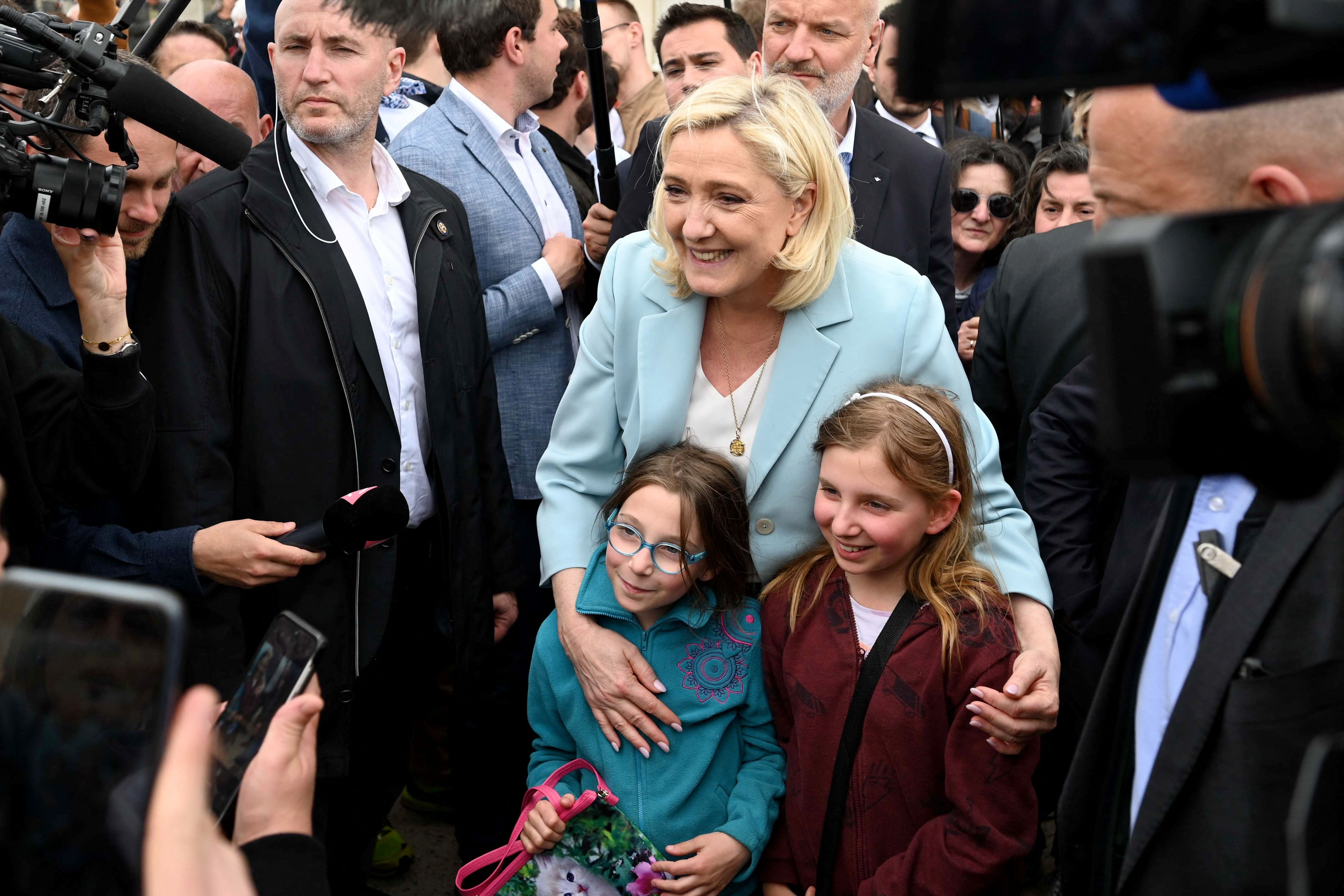 Marine Le Pen poses for a picture during her visit to the coastal city of Berck