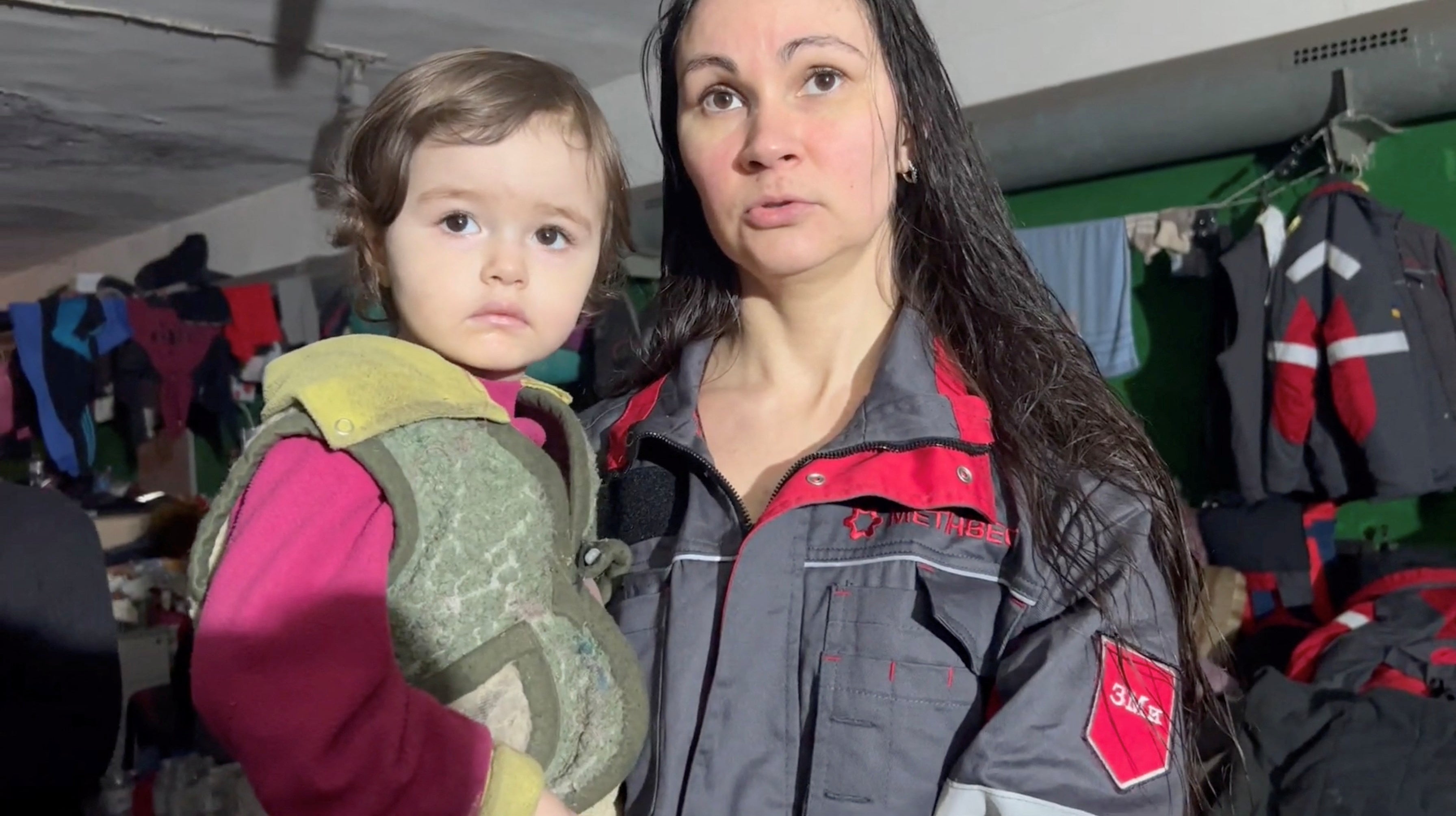 A woman holding a child speaks as they take shelter in Azovstal steelworks in Mariupol