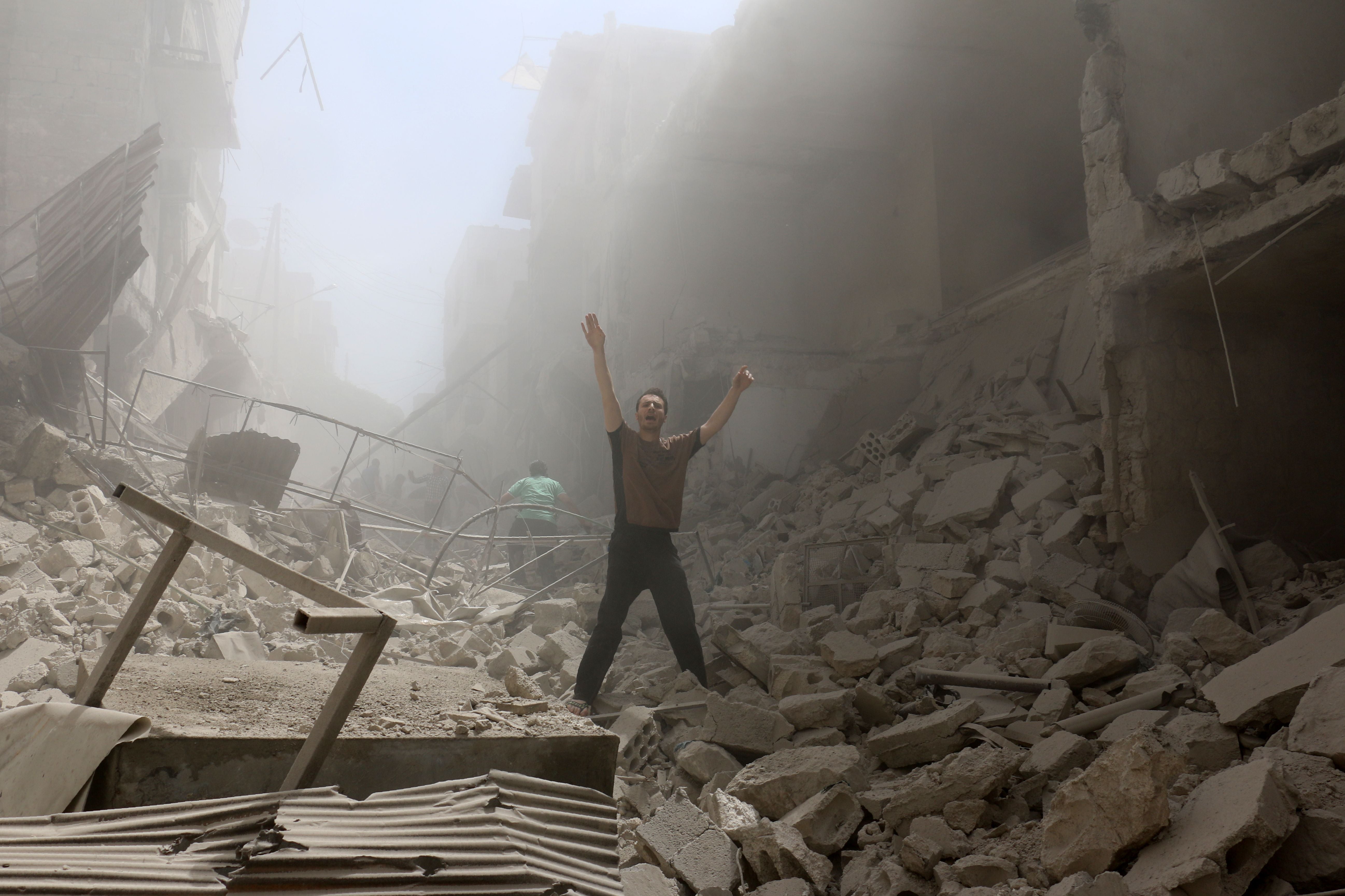 A man amid the rubble of destroyed buildings after an air strike on the rebel-held neighbourhood of al-Kalasa in Aleppo