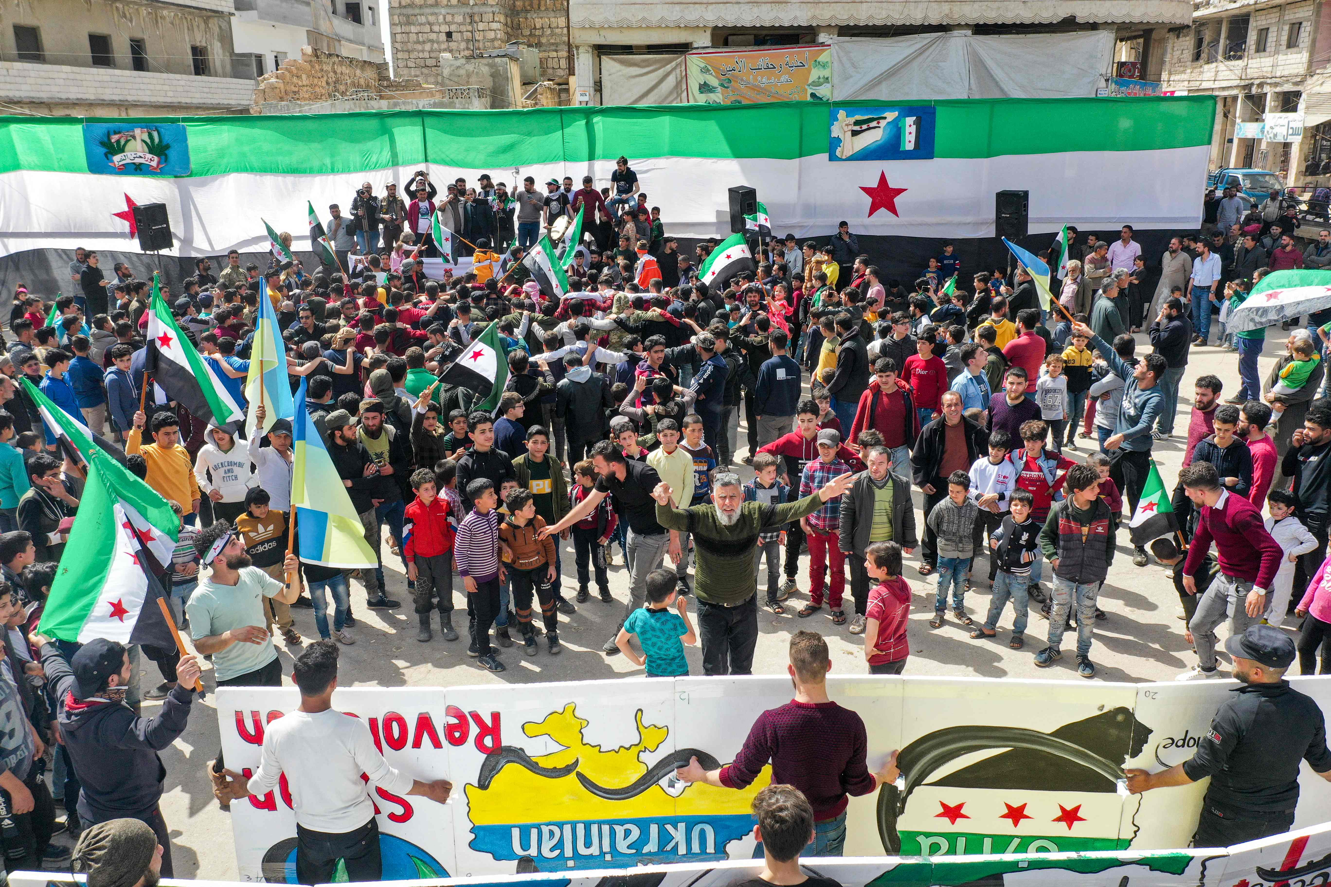 An aerial view of a demonstration in the city of Binnish in Syria’s northwestern rebel-held Idlib province against Russia’s invasion of Ukraine