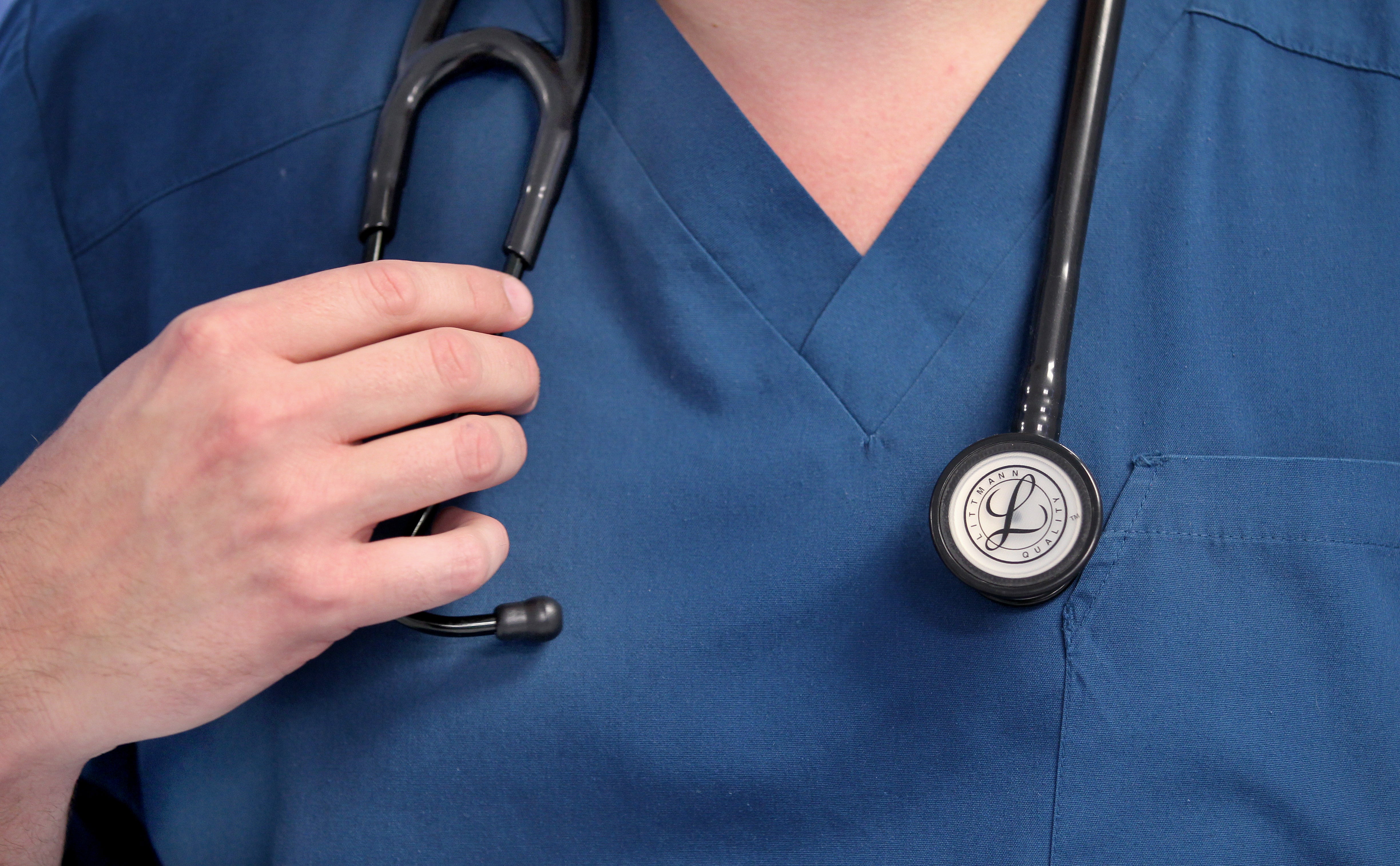 A Doctor holds a stethoscope at the Royal Liverpool University Hospital, Liverpool (PA)