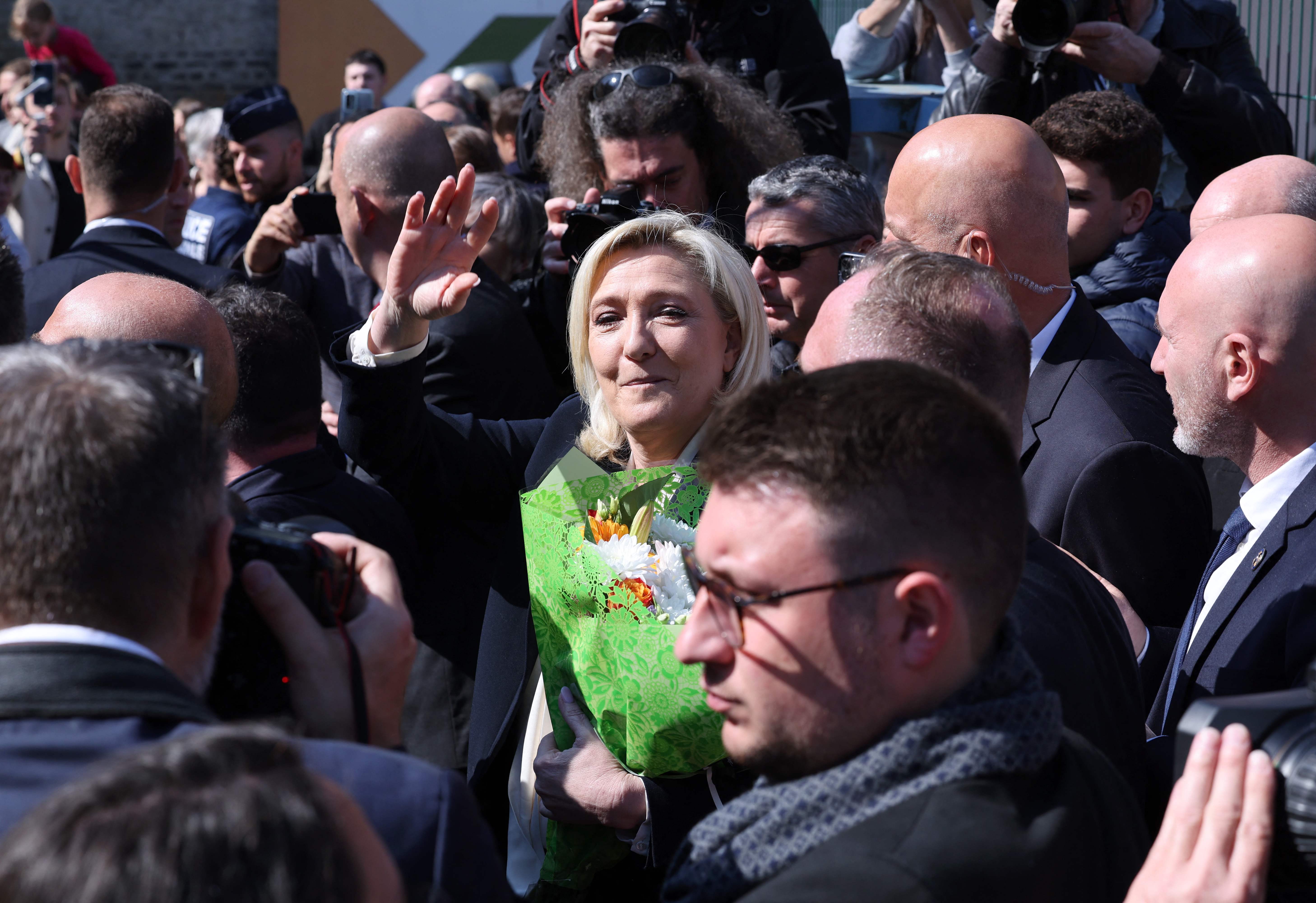 Marine Le Pen leaves the polling station in Henin-Beaumont, northern France