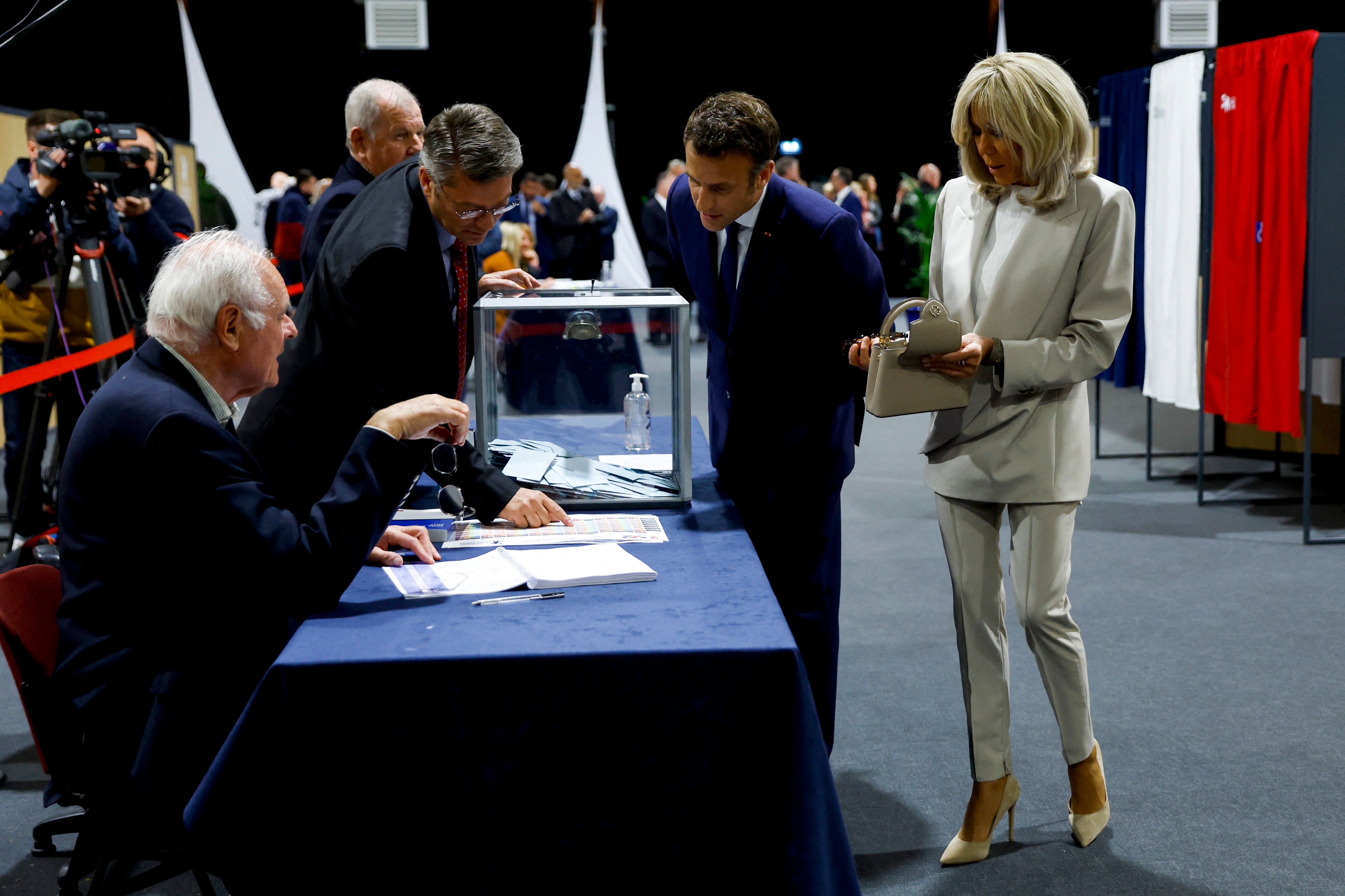 Mr Macron and his wife Brigitte at a polling station